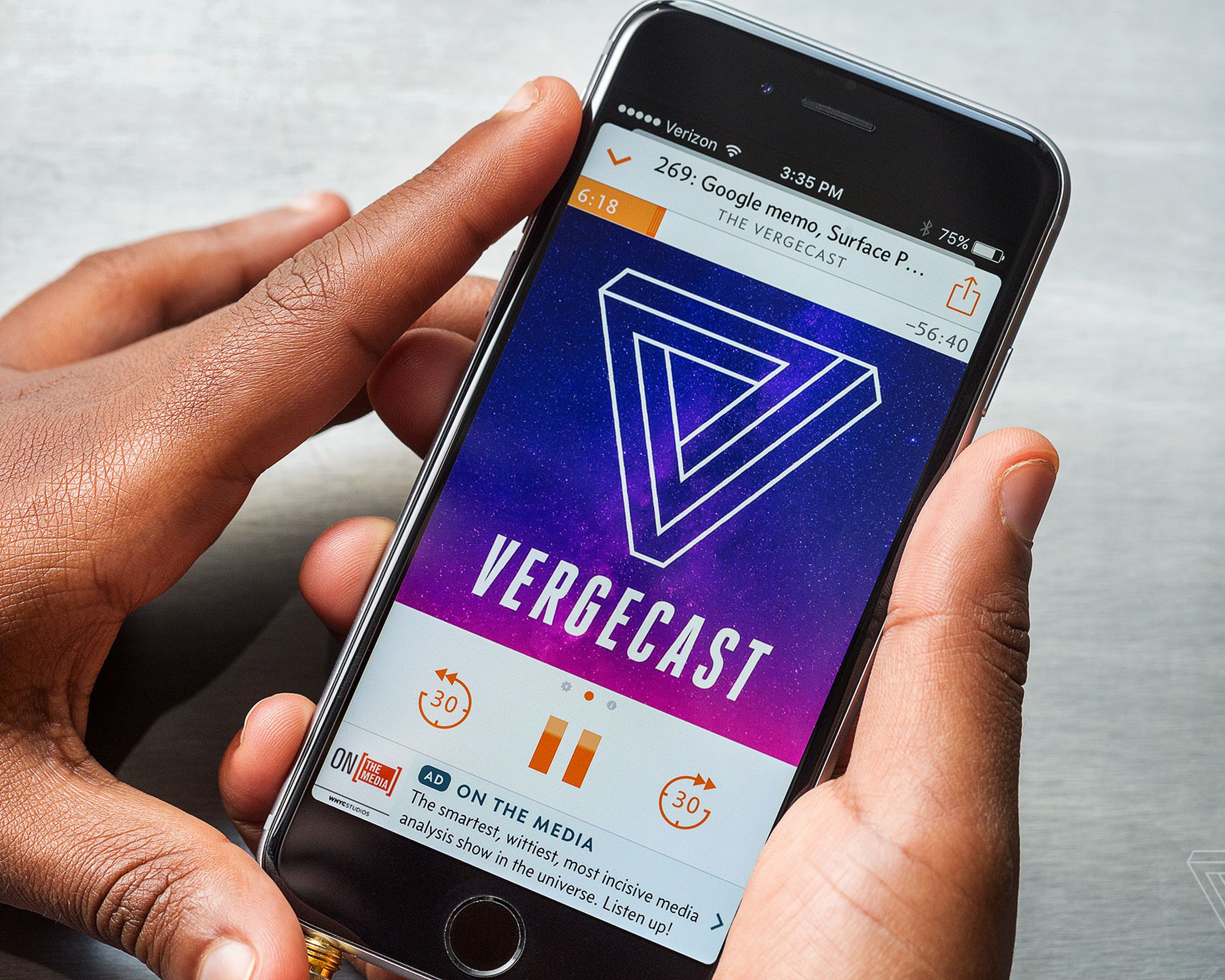 A close-up image of a phone, the Vergecast logo is prominent, and the UI around it is the orange Overcast one.