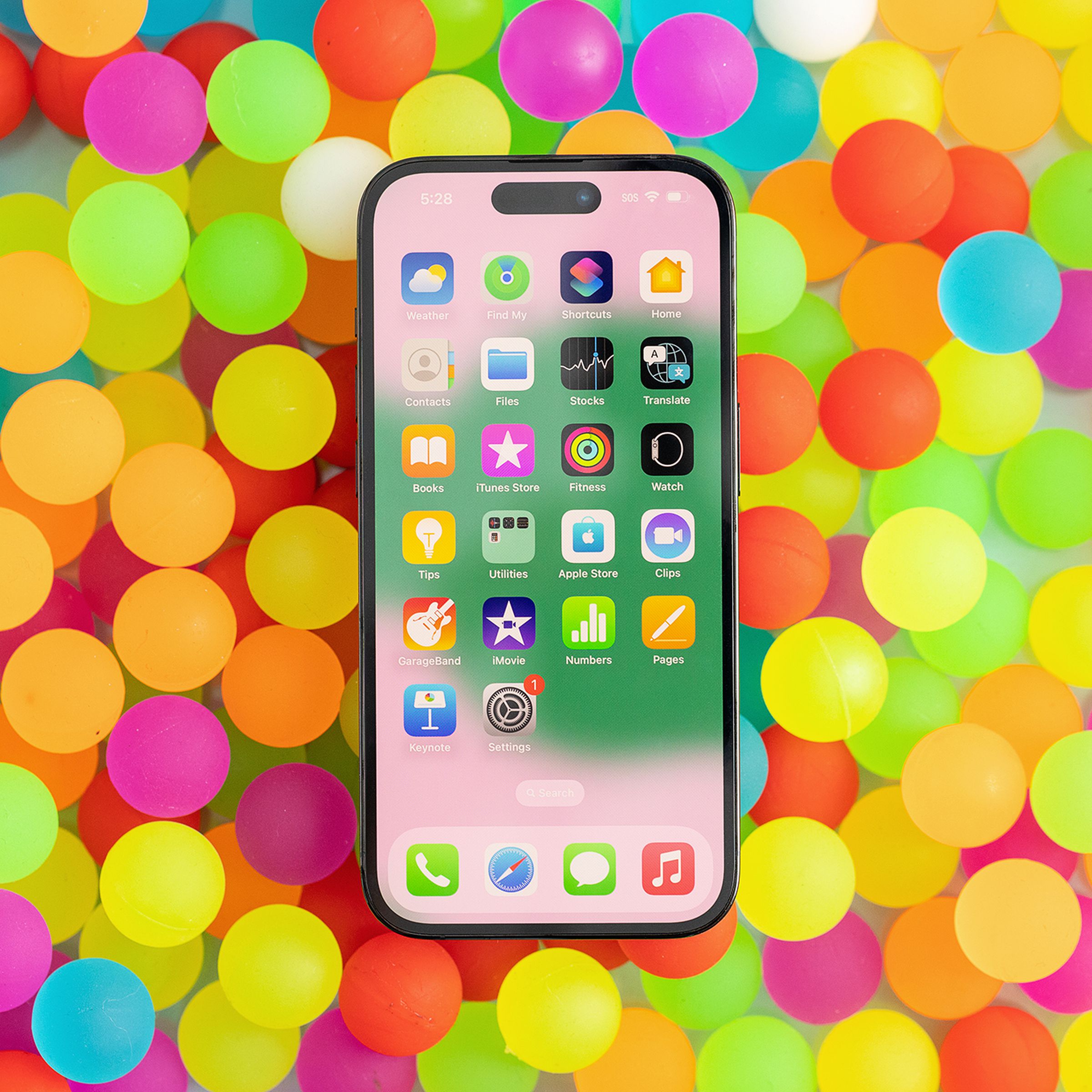 Photo of an iPhone on top of multi-colored pastel circles.