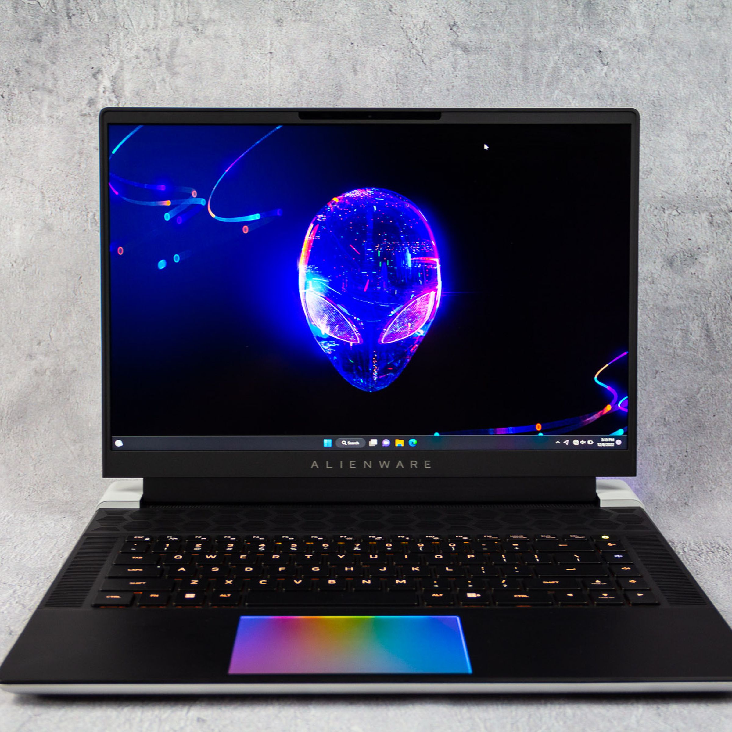 Alienware’s X16 16-inch gaming laptop with its display opened to reveal a multi-colored trackpad.