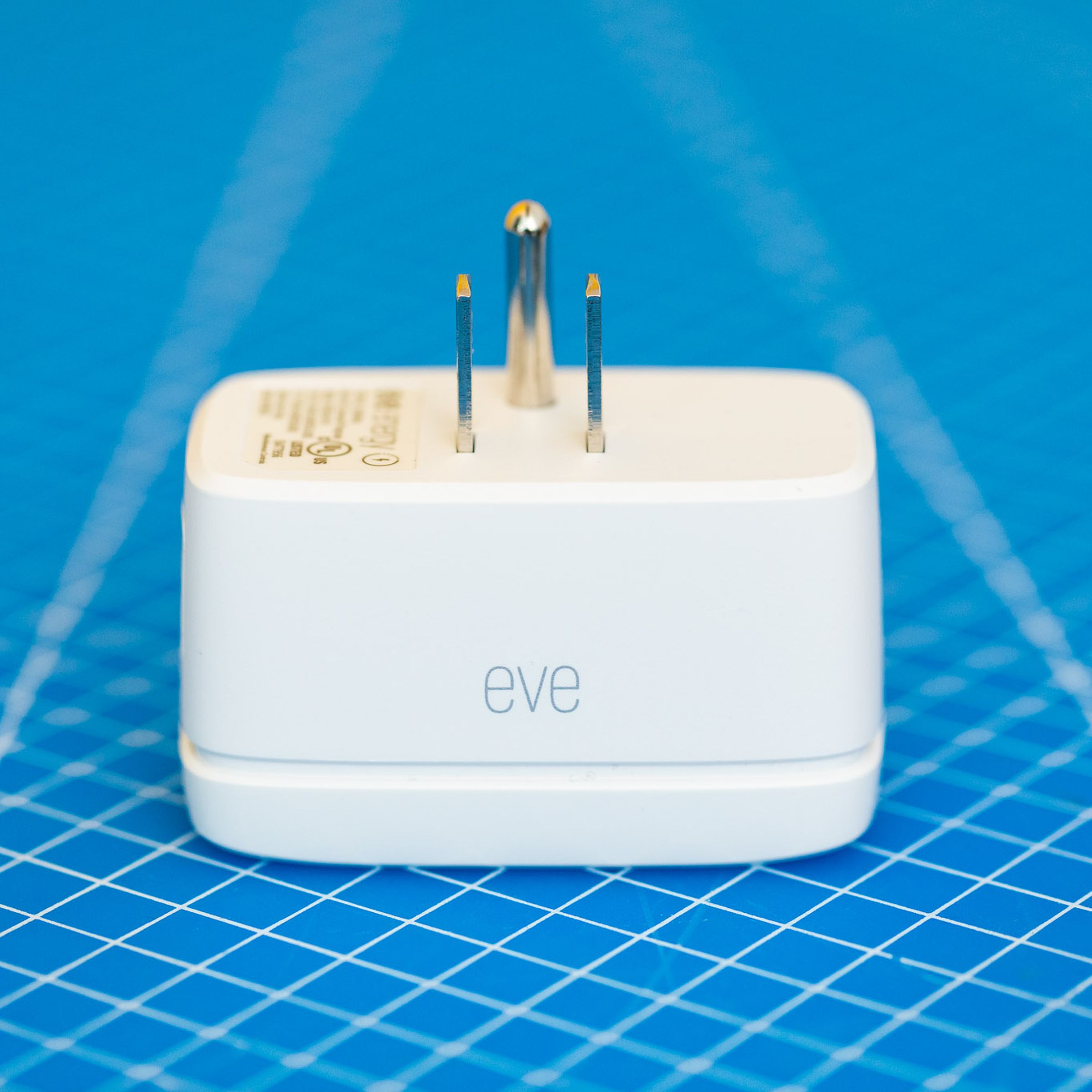A white smart plug on a blue background