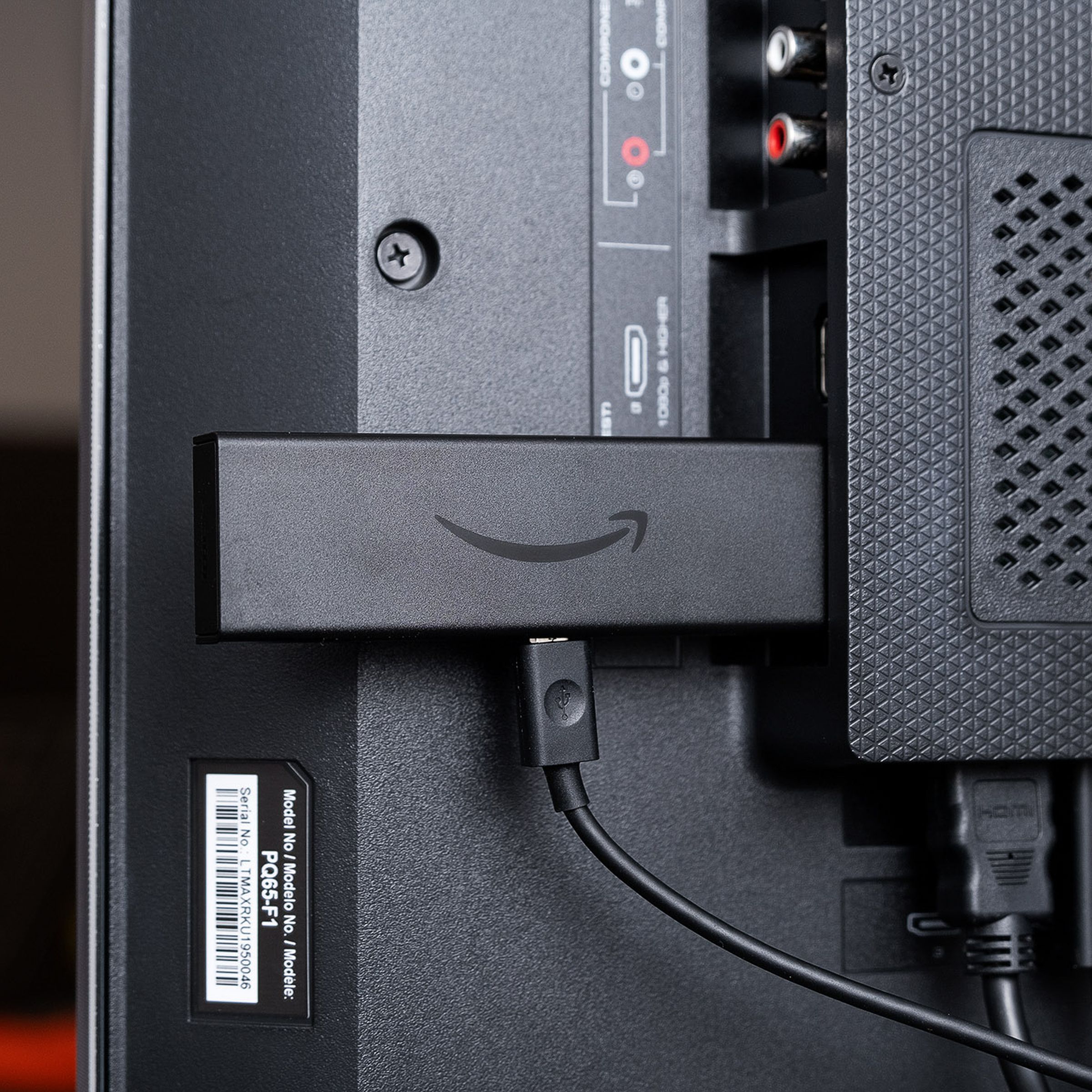Amazon’s Fire TV Stick 4K, a great streaming stick for $50, pictured attached to a TV’s HDMI port.