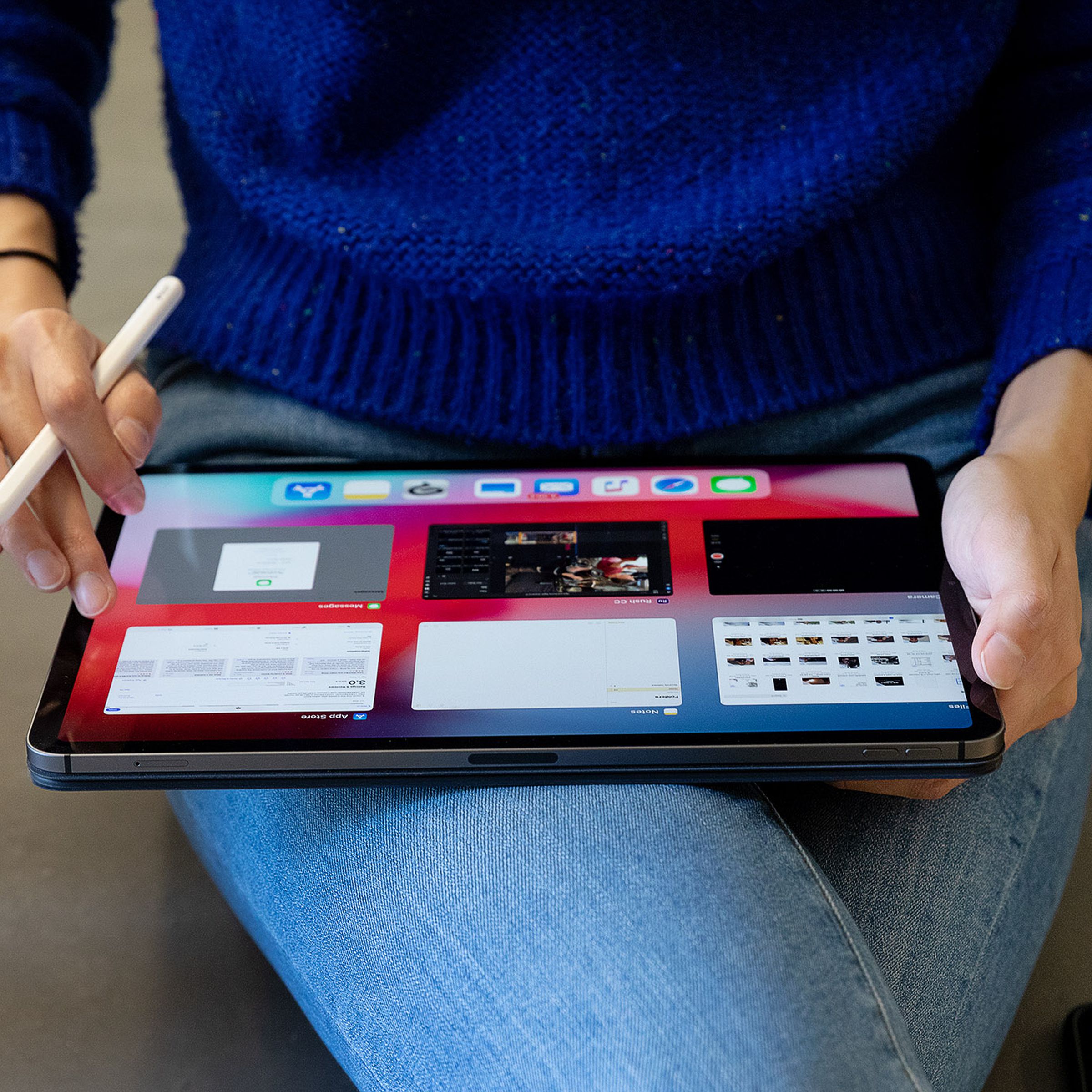 A person using an Apple Pencil on an iPad Pro tablet.