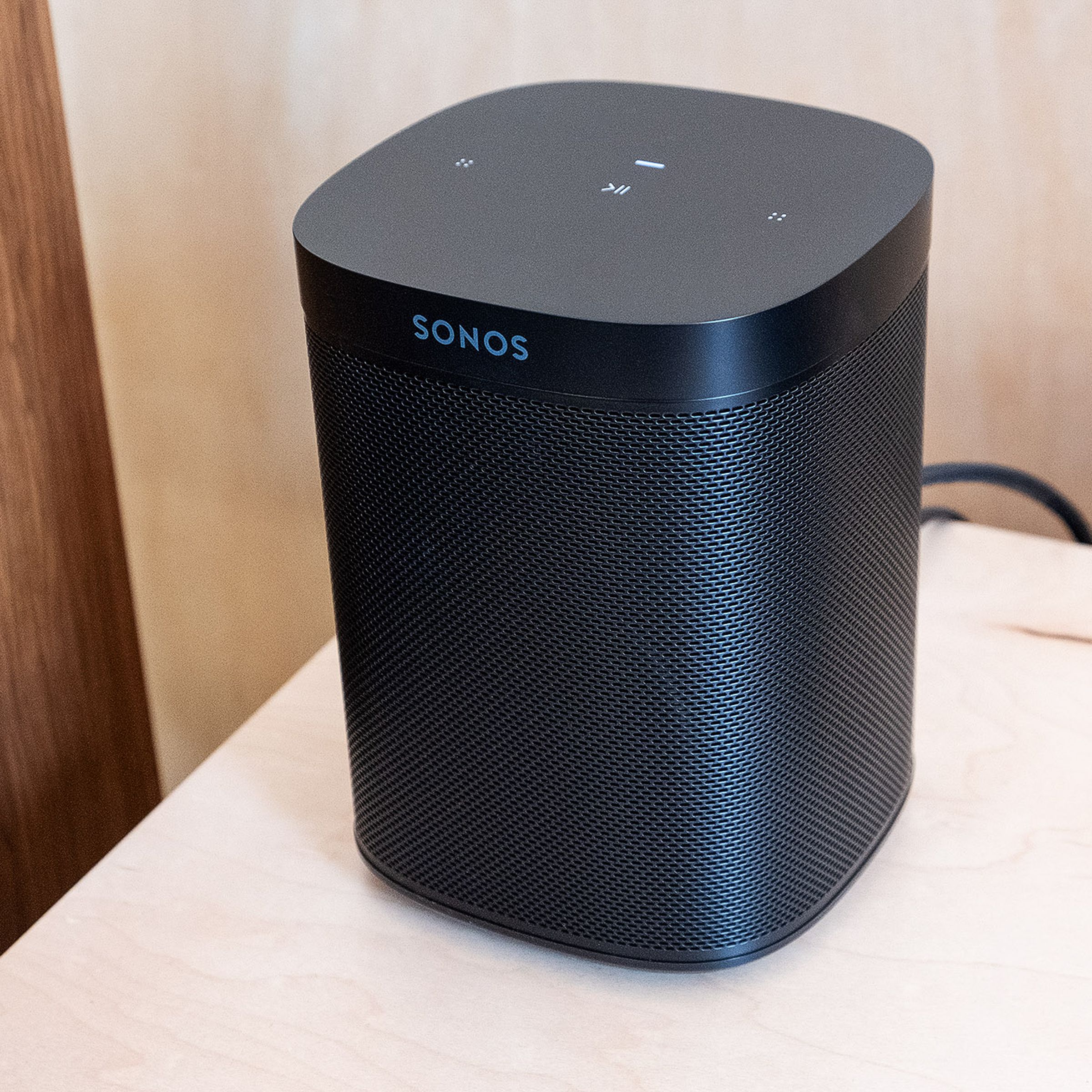 The Sonos One SL sitting on a table.