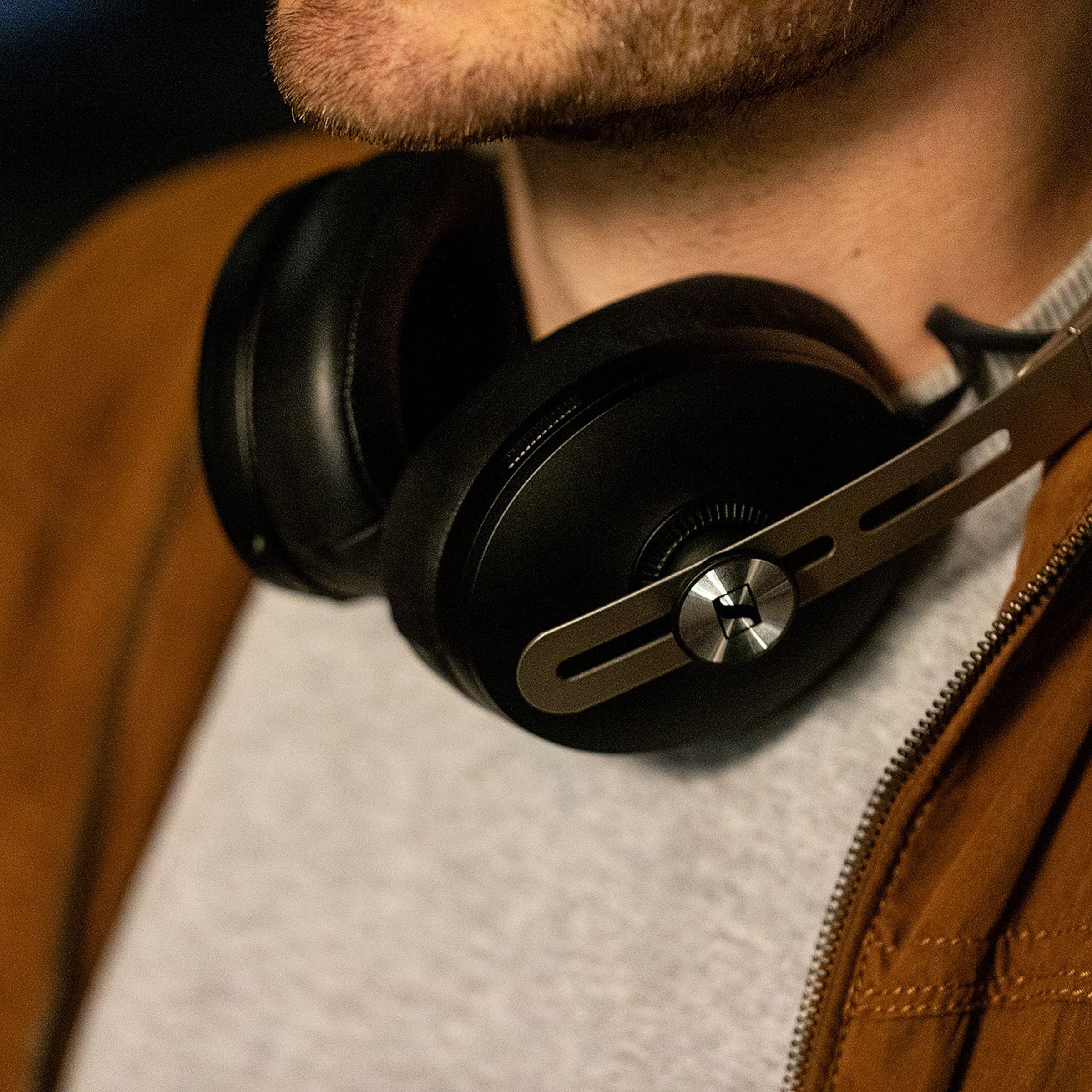 A photo of Sennheiser’s Momentum Wireless 3 headphones, previously our best noise-canceling headphones for sound quality, worn around someone’s neck.