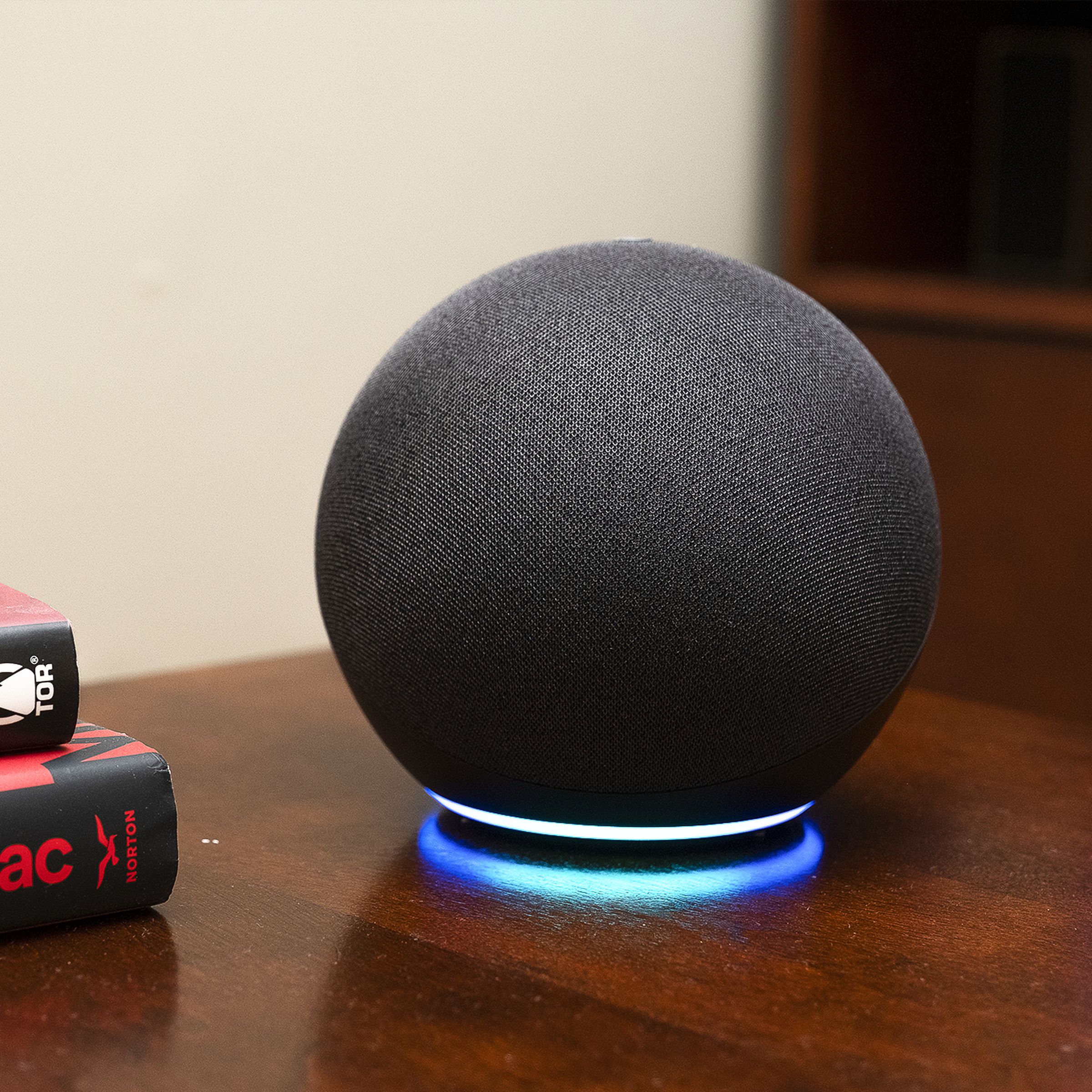 The fourth-gen Echo smart speaker on a wooden desk