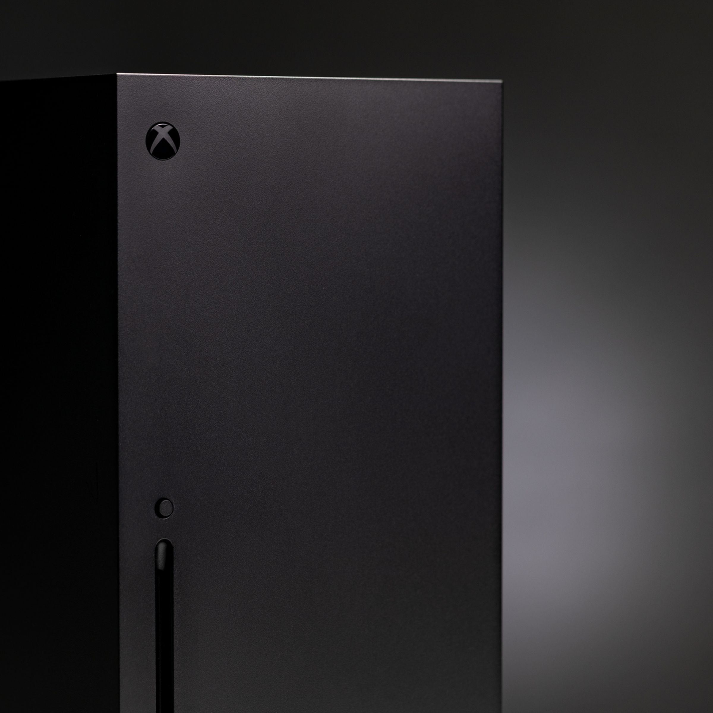 The Xbox Series X in front of a black background.
