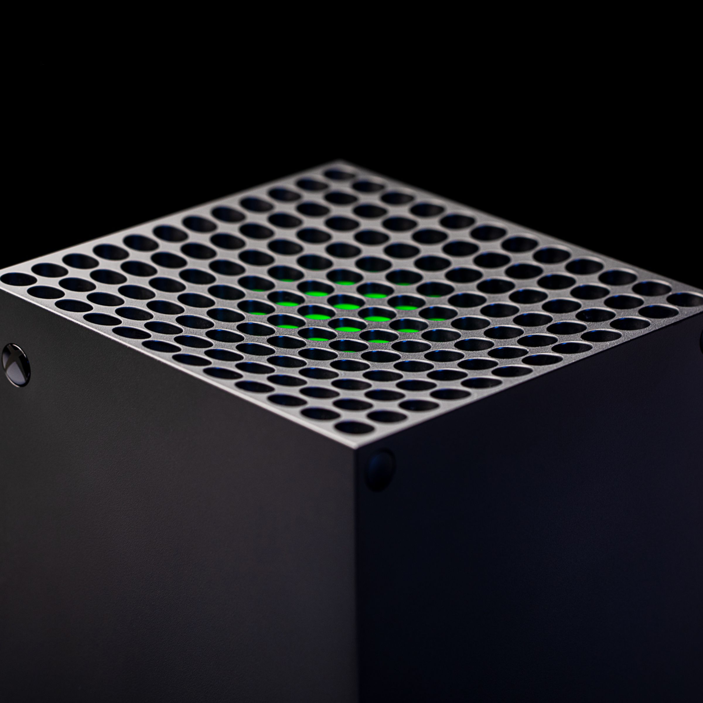 The upper part of the Xbox Series X placed against a black background.