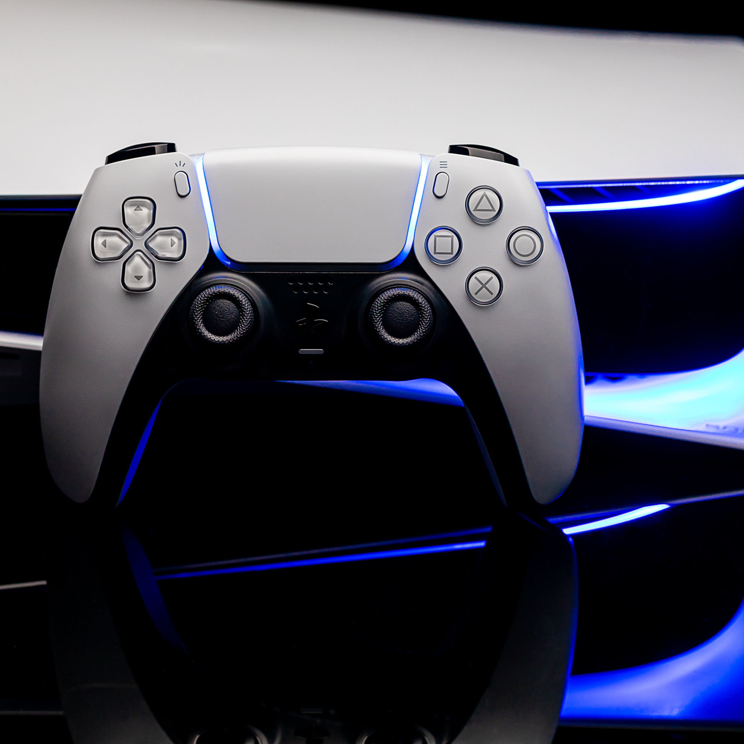 A PlayStation 5 DualSense controller rests on a PlayStation 5 console.