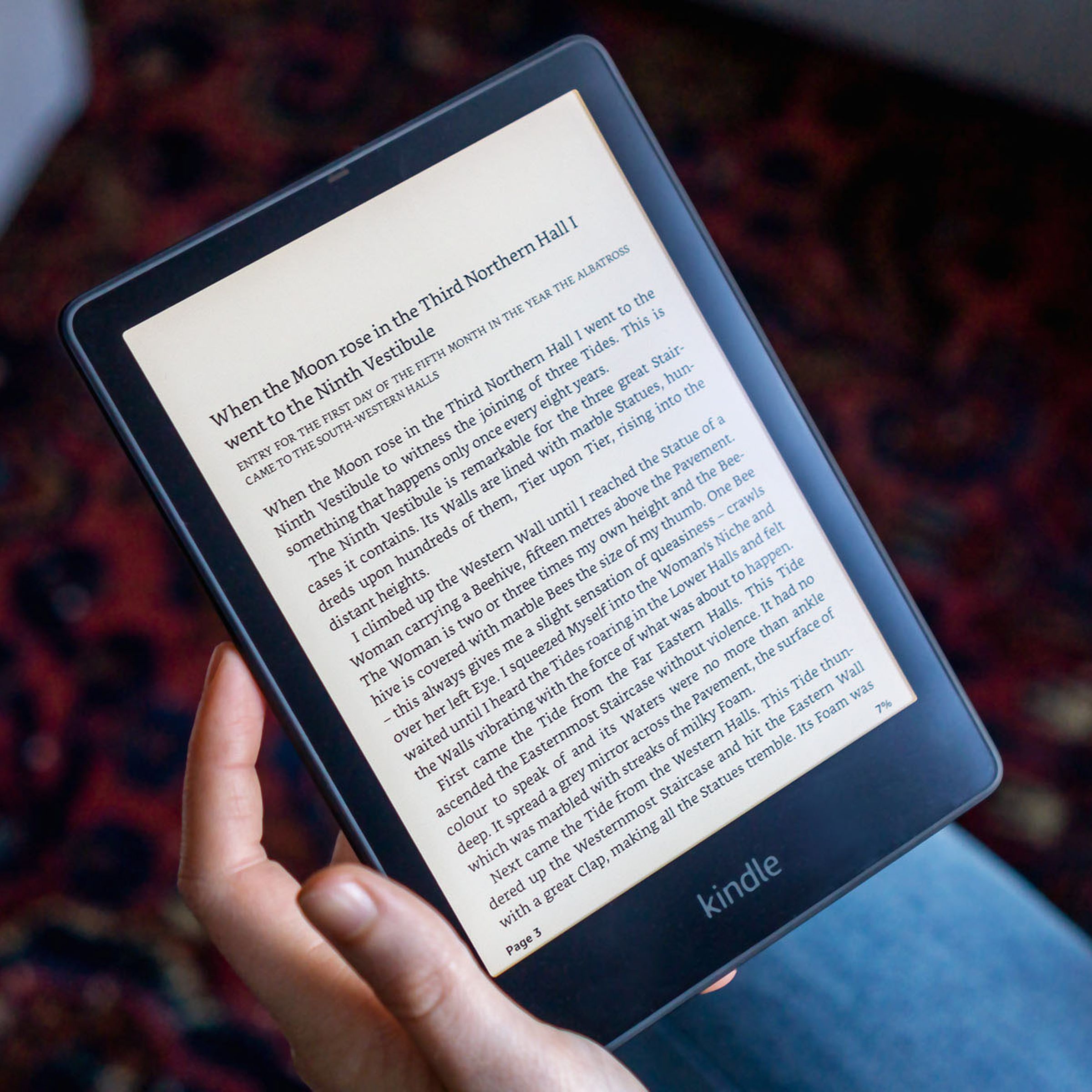 A person holding a Kindle Paperwhite