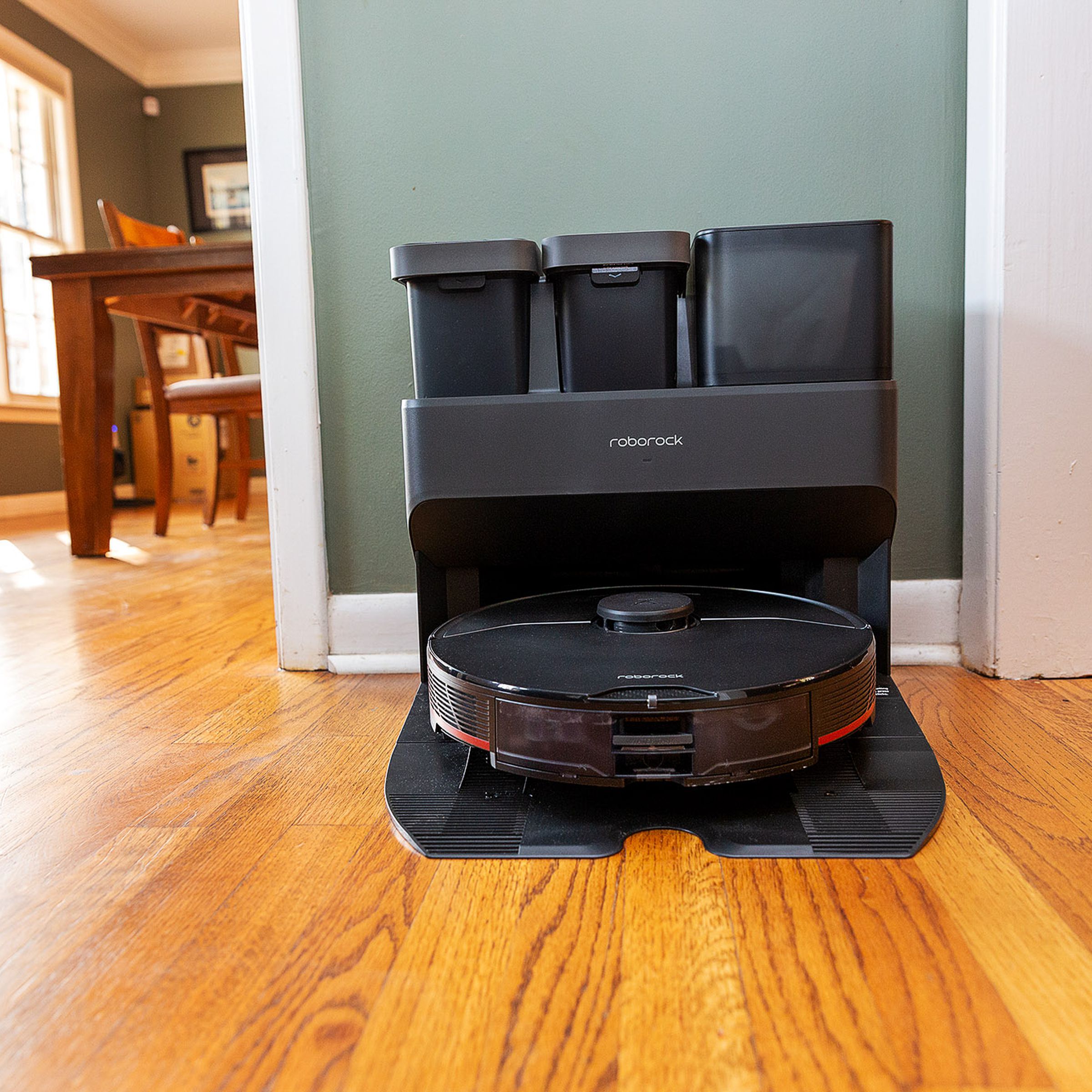 A robot vacuum and its docking station in a living room.