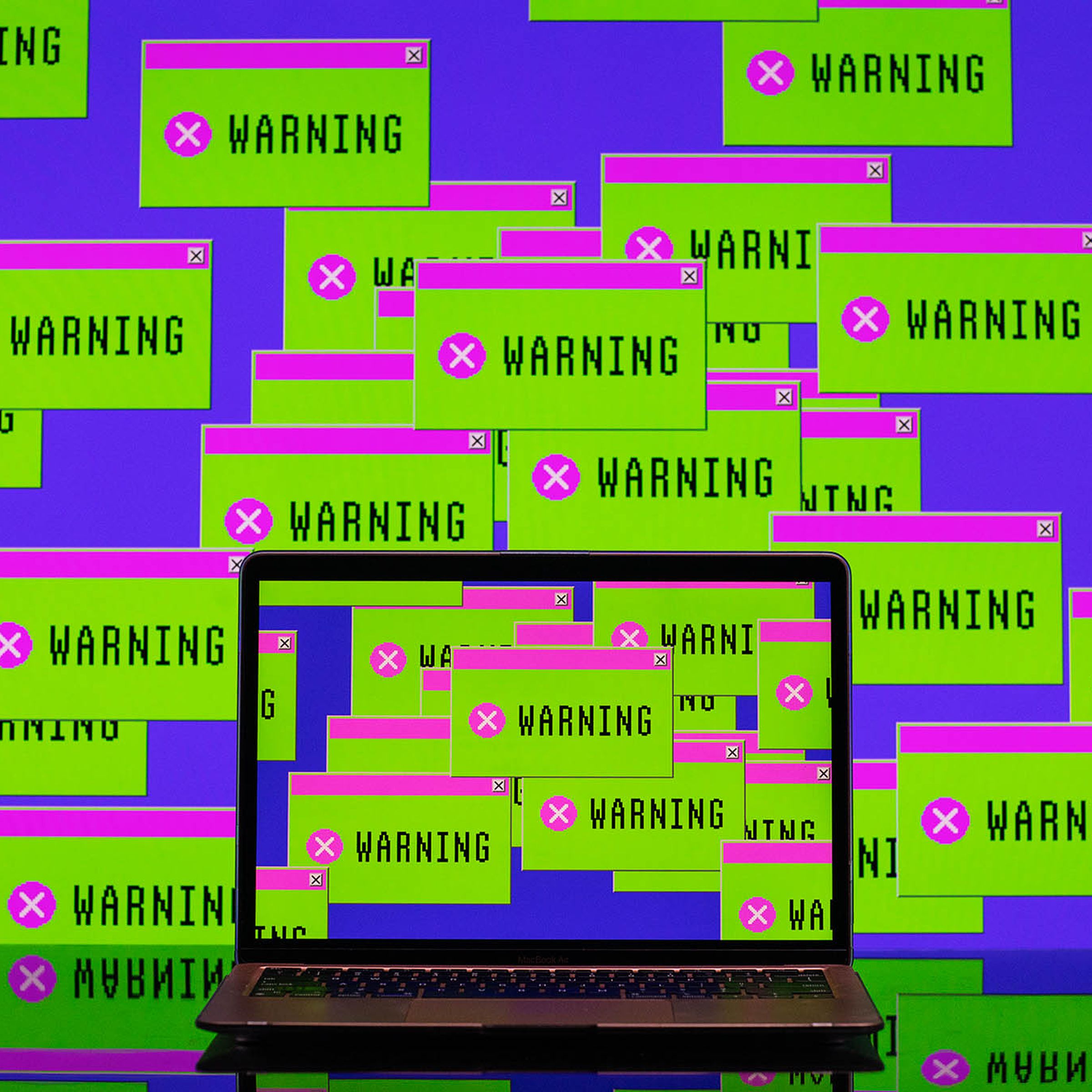 A laptop surrounded by green and pink message boxes that say “warning.”