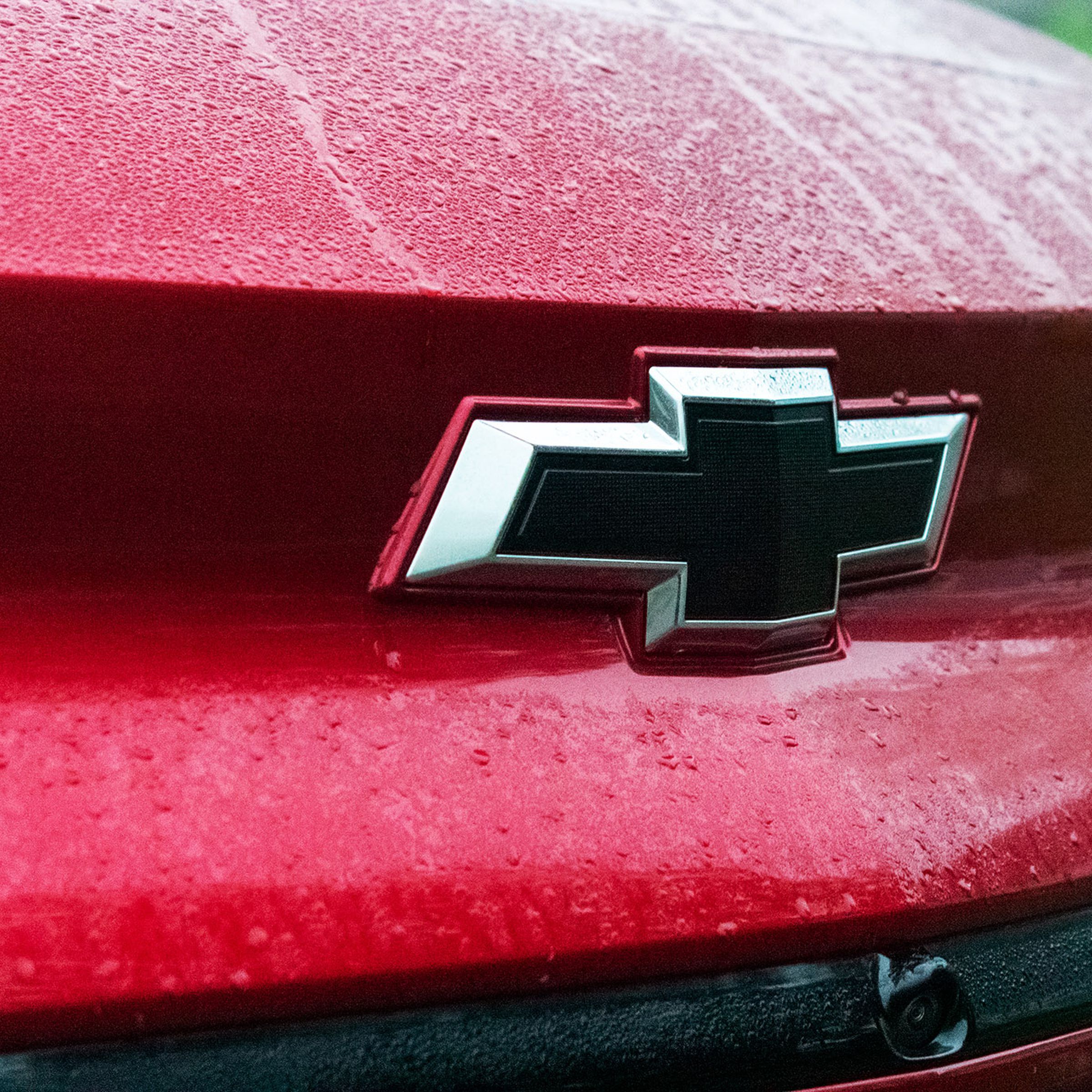 The Chevy logo on the front of a red vehicle