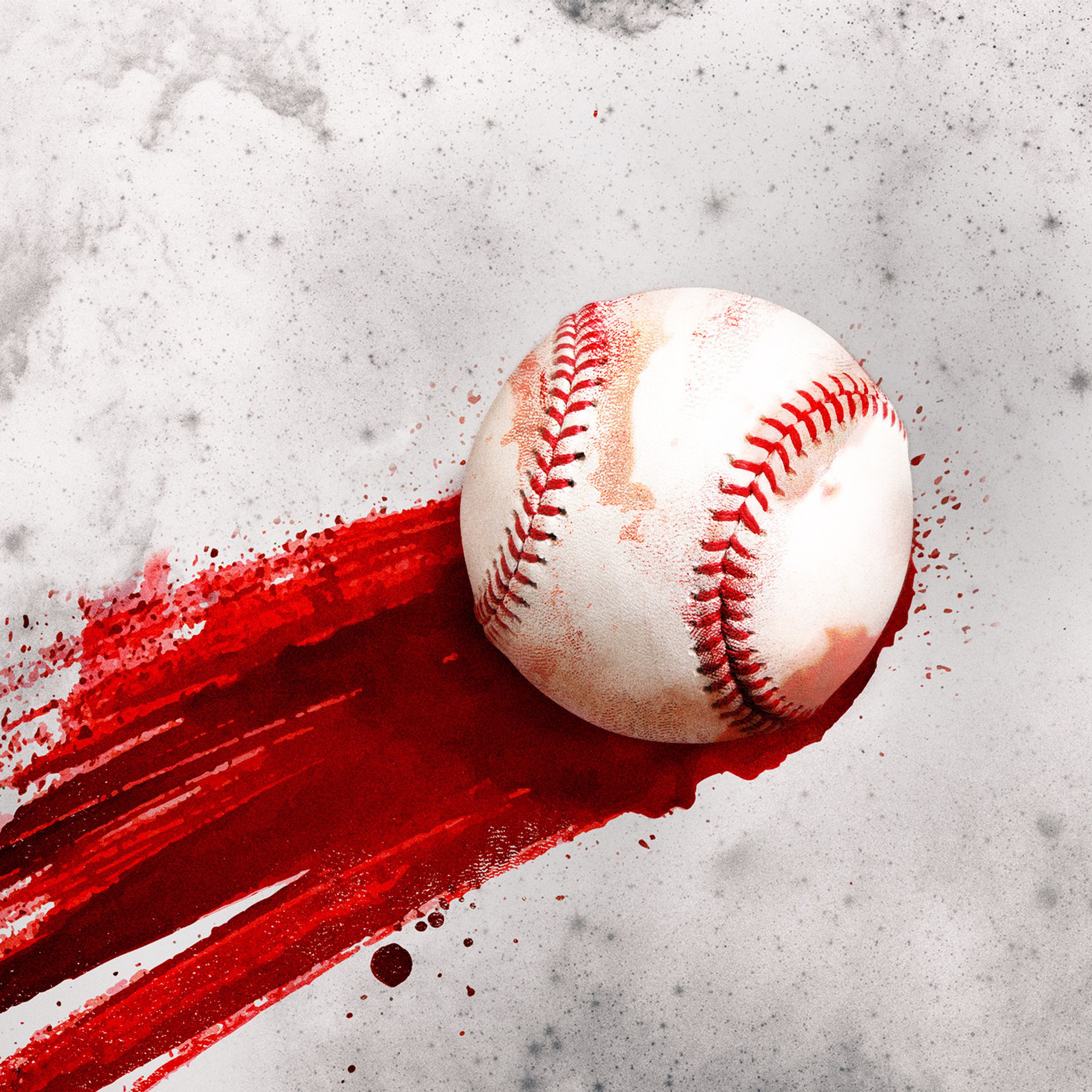 A baseball lays on a surface streaked with blood.