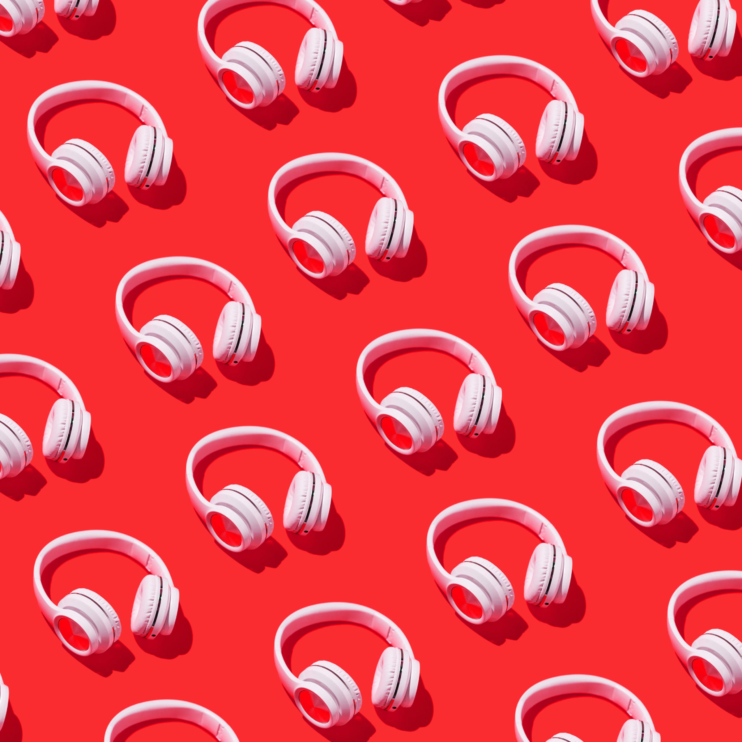 Red background with a repeating pattern of white headphones.