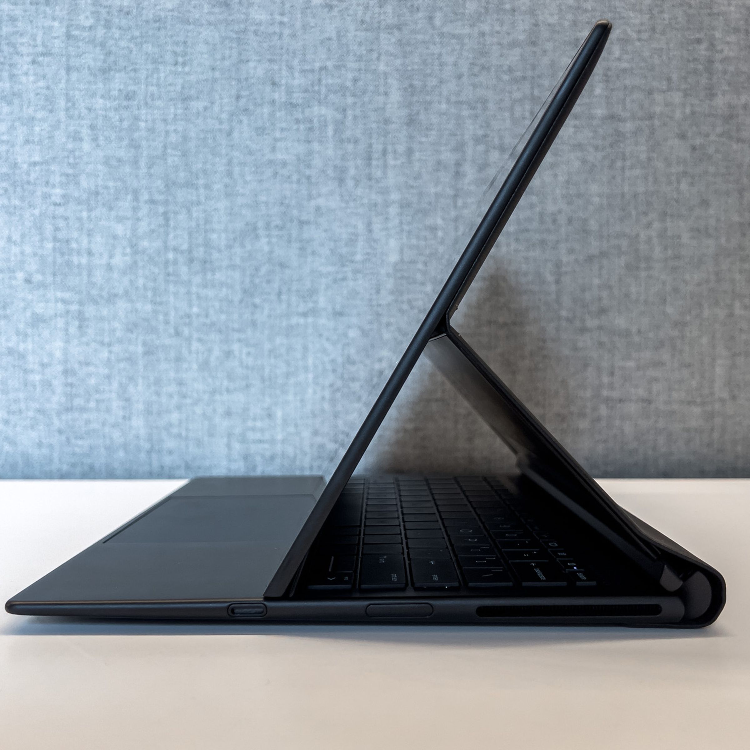 The HP Dragonfly Folio G3 on a desk in folio mode, seen from the side.
