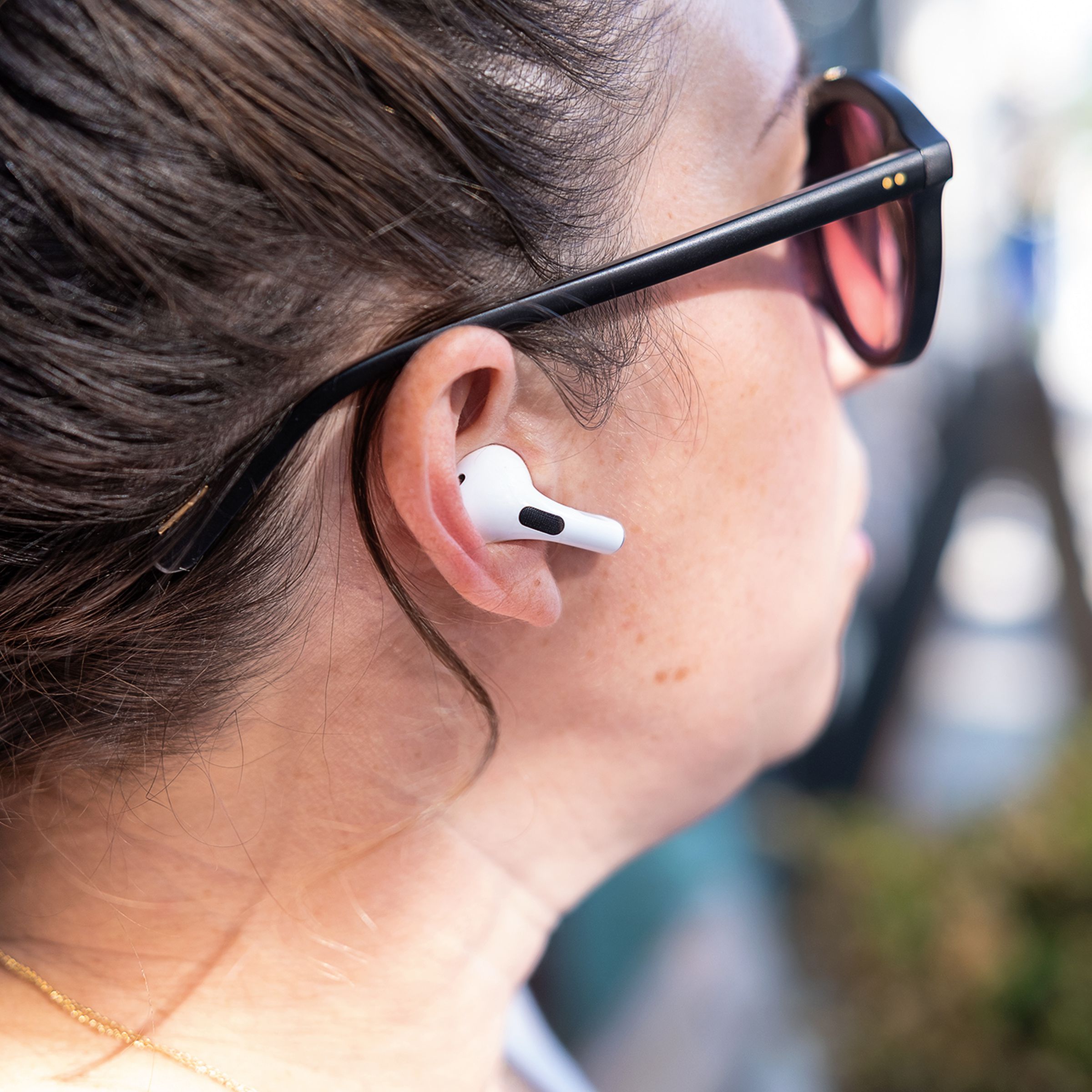 Apple’s second-generation AirPods Pro pictured in a side profile photo of a woman’s head.