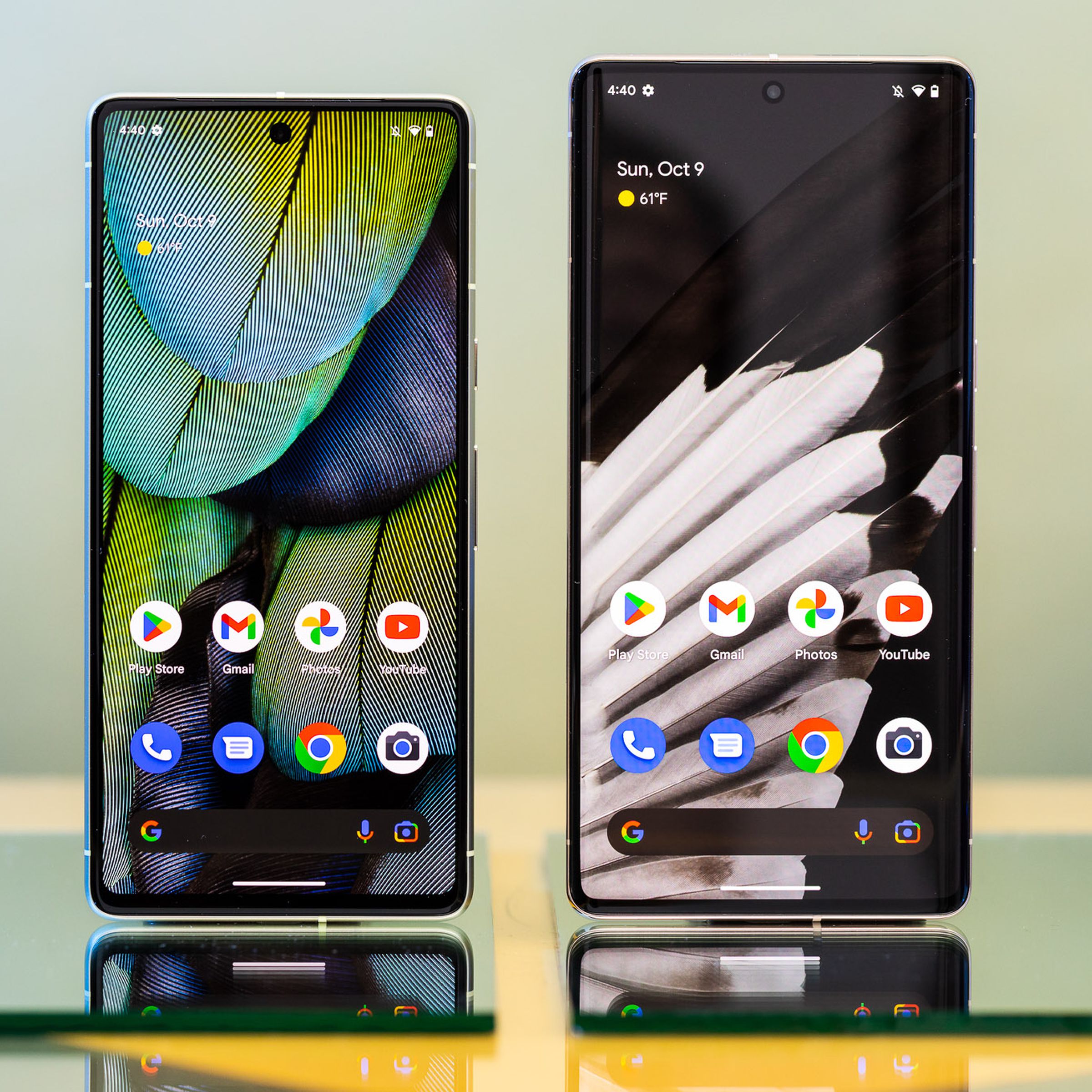 Pixel 7 and Pixel 7 Pro standing upright with screens on.
