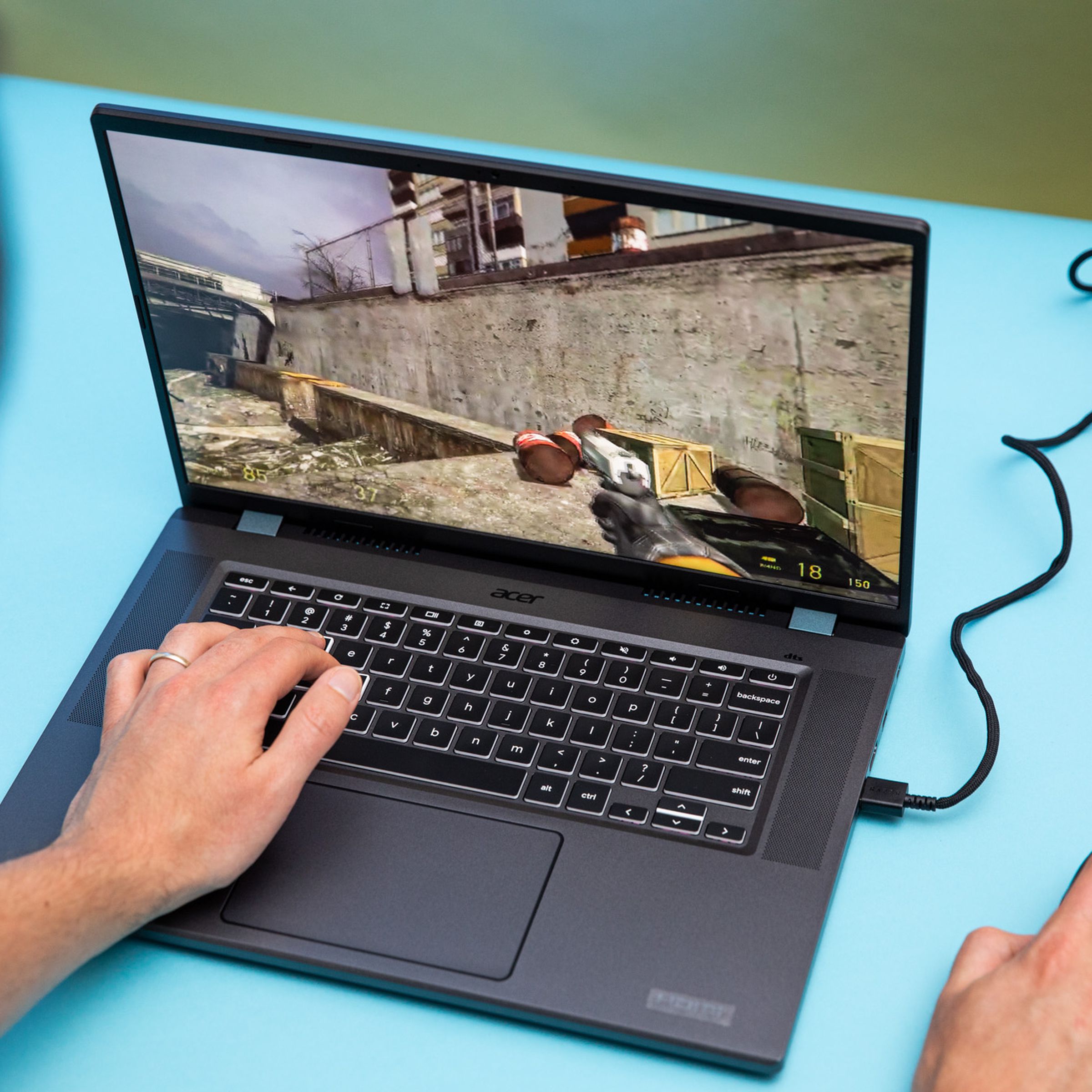 The Acer Chromebook 516 GE gaming laptop with a mouse plugged into its USB port. It’s running the game Half-Life 2.