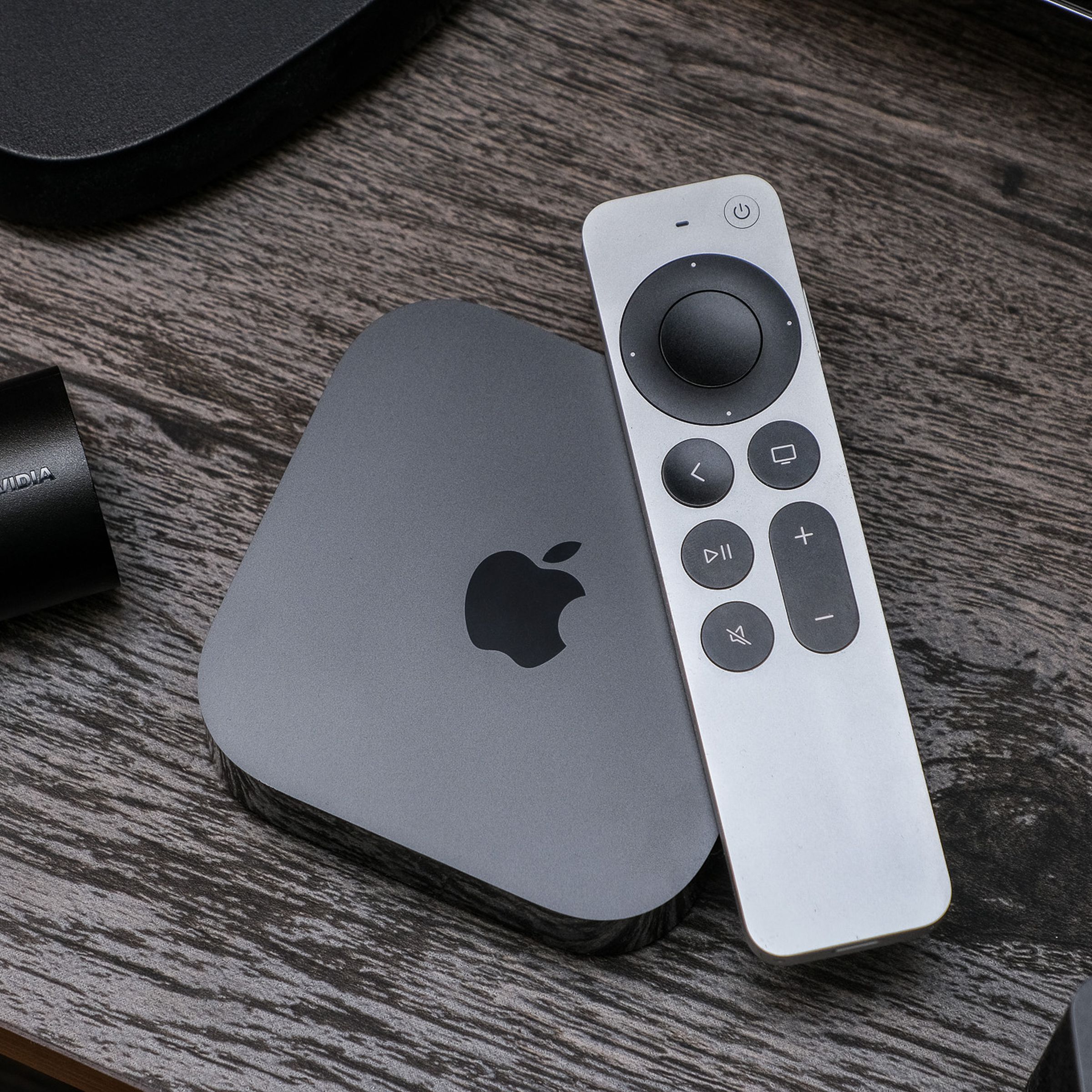 A photo of the third-gen Apple TV 4K on a TV stand.