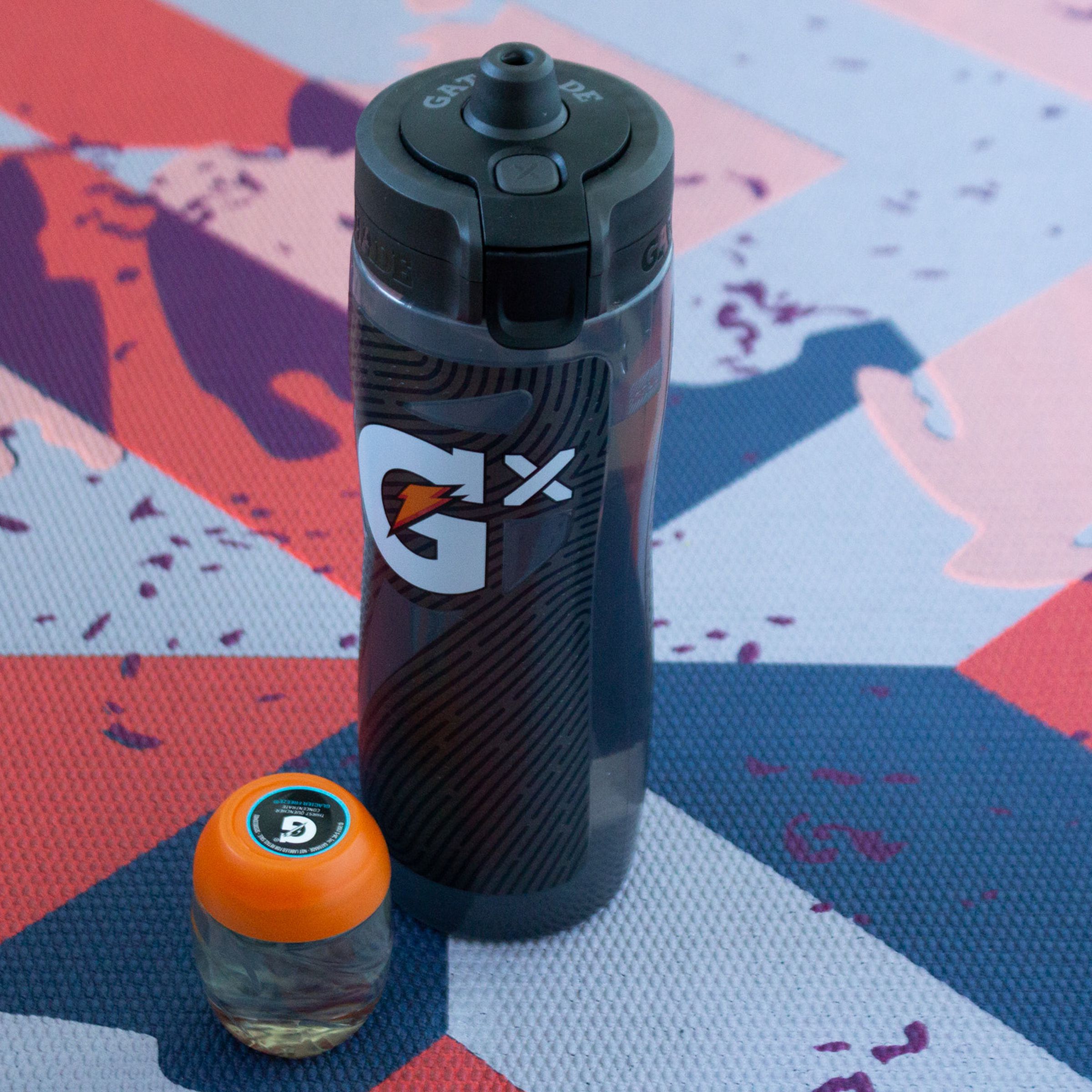 Gatorade Smart Gx bottle on a yoga mat with a Gx pod next to it.