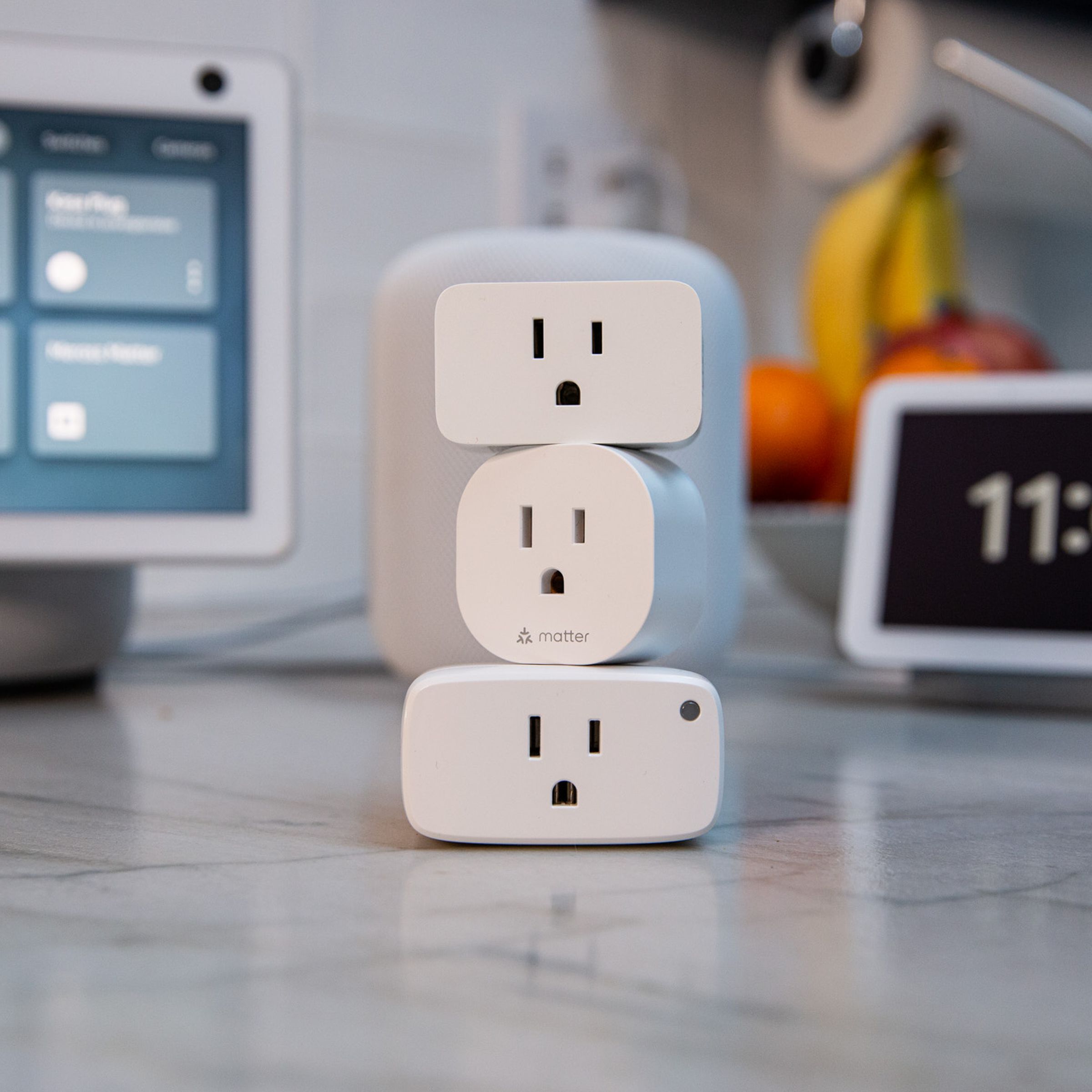A stack of Matter-compatible smart plugs from Eve and TP-Link.