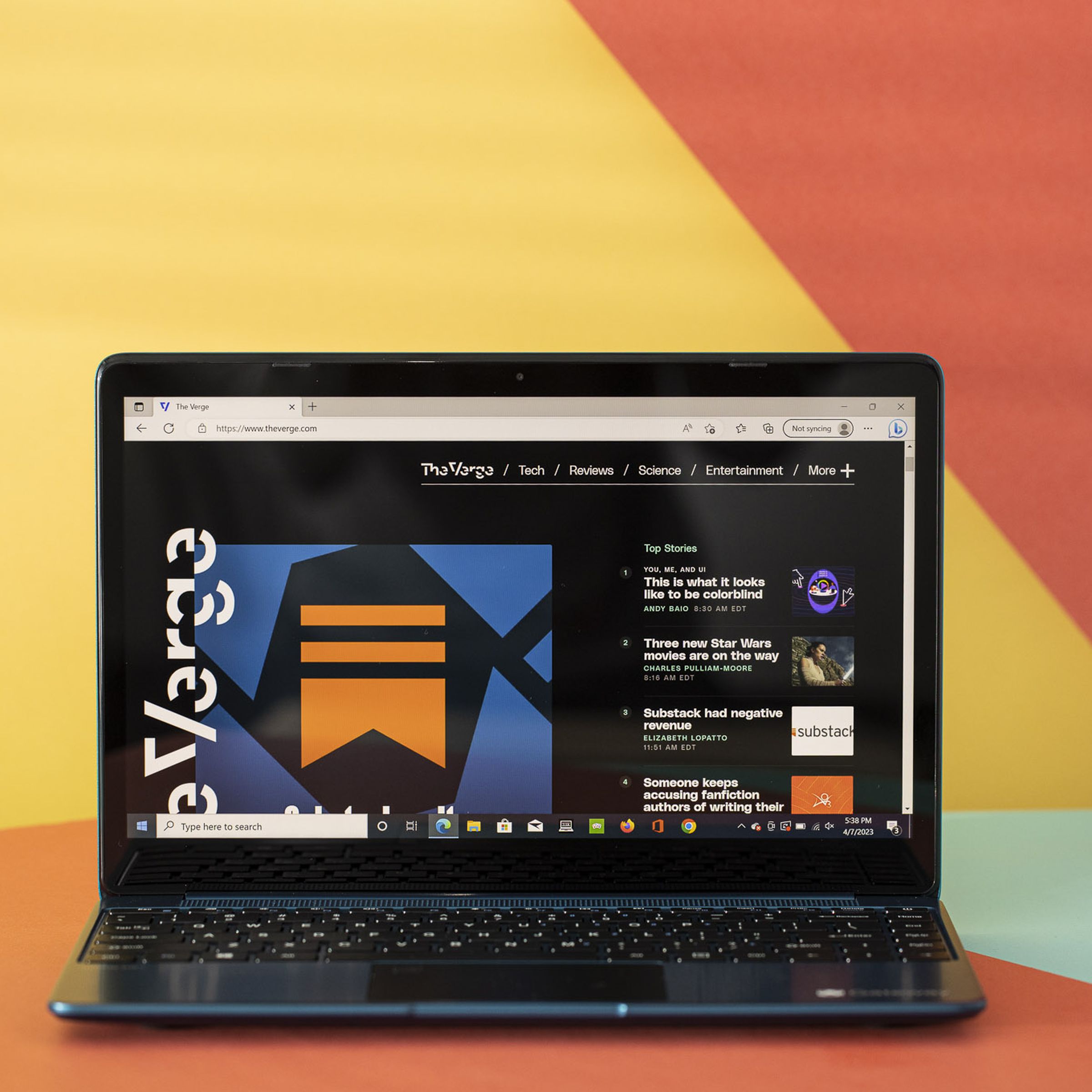 The Gateway 14 displaying The Verge homepage on an orange and yellow background.