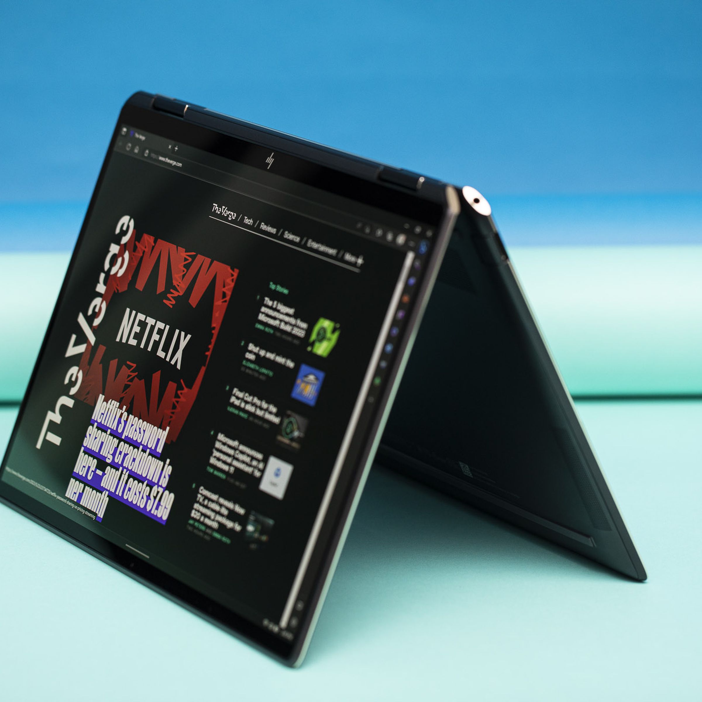 The HP Spectre x360 13.5 in tent mode displaying The Verge homepage.