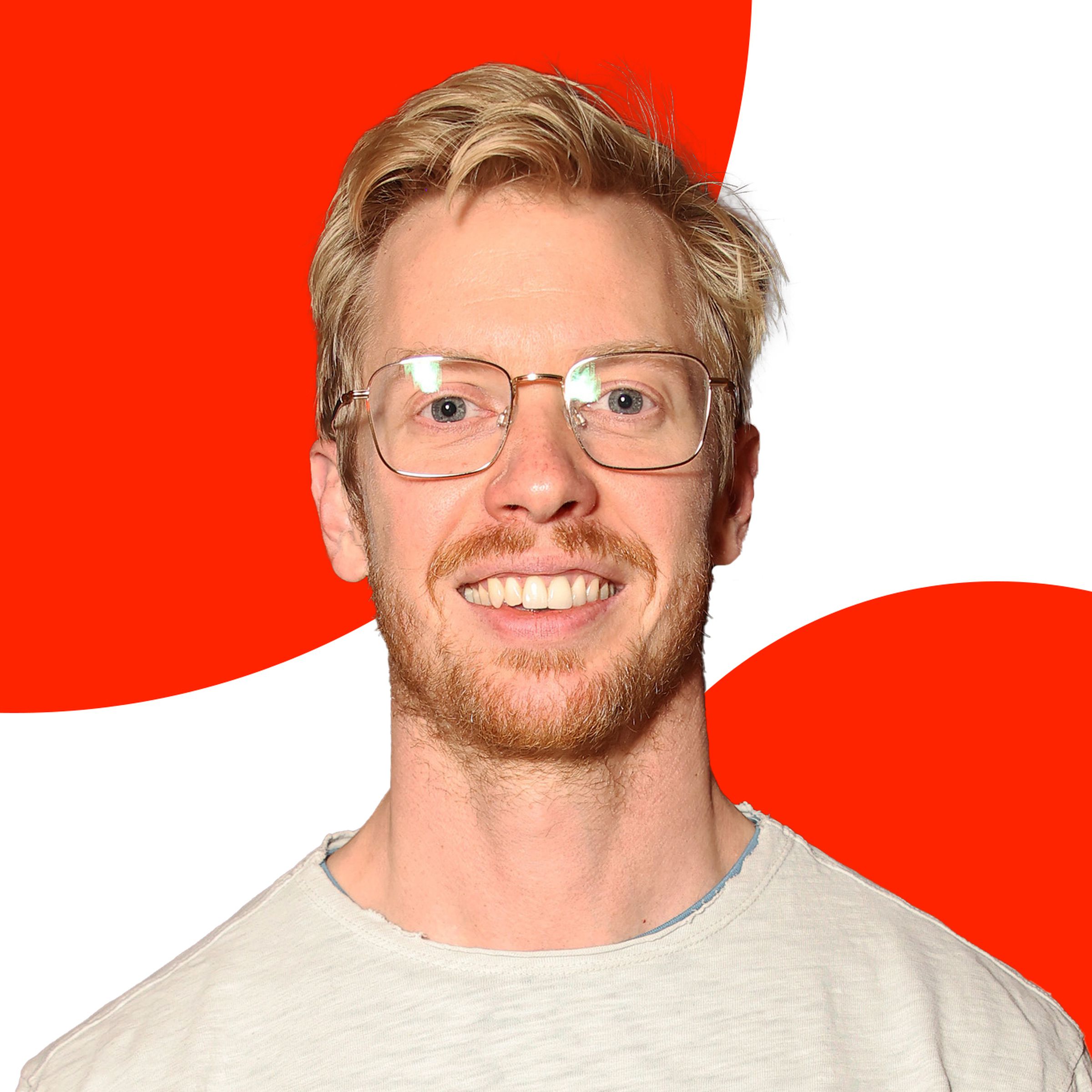 A photo of Reddit CEO Steve Huffman over an orange and white background.