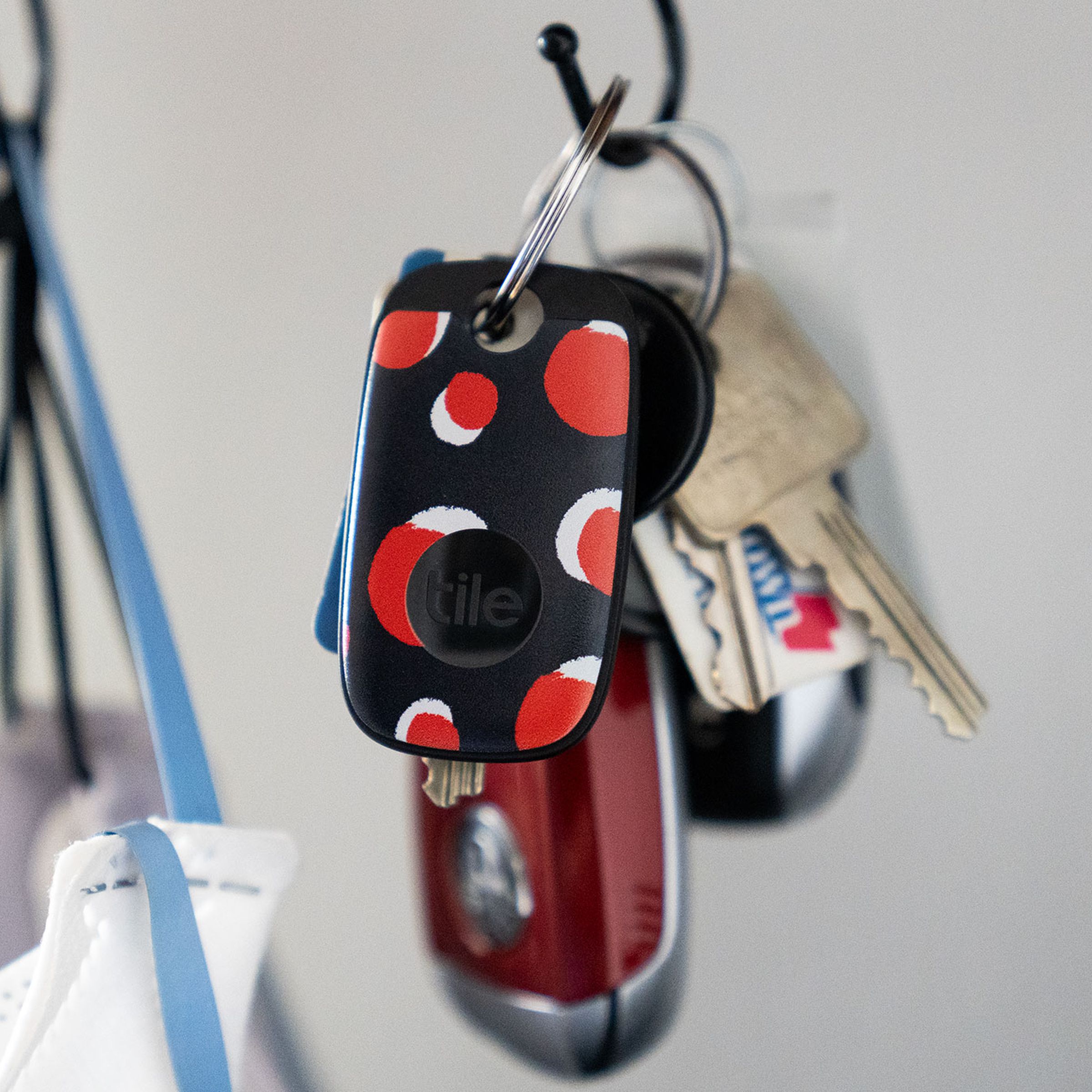 Colorful Tile Pro hanging from a key ring on a hook