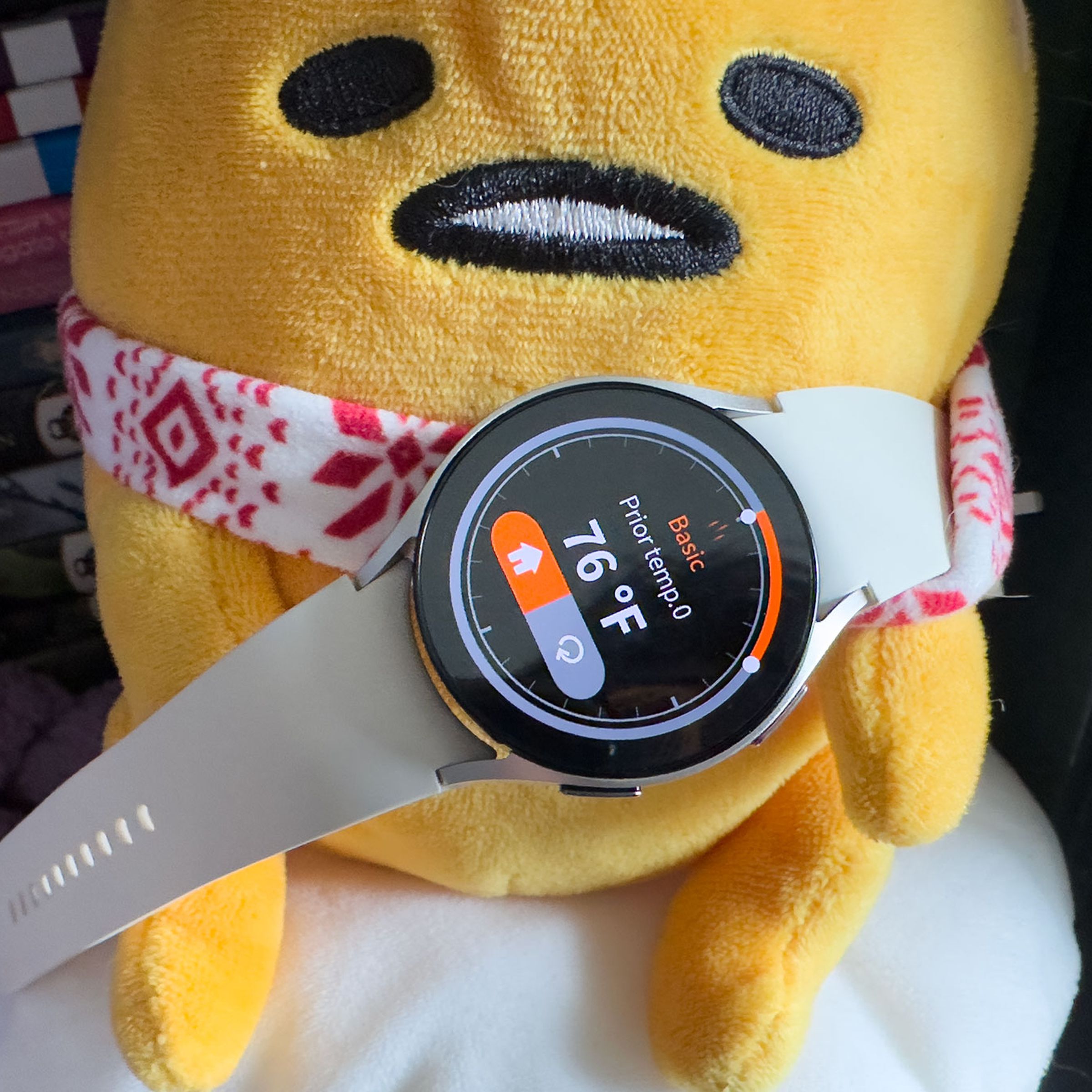 Samsung Galaxy Watch 6 showing the Thermo Check app on a Gudetama plushie.