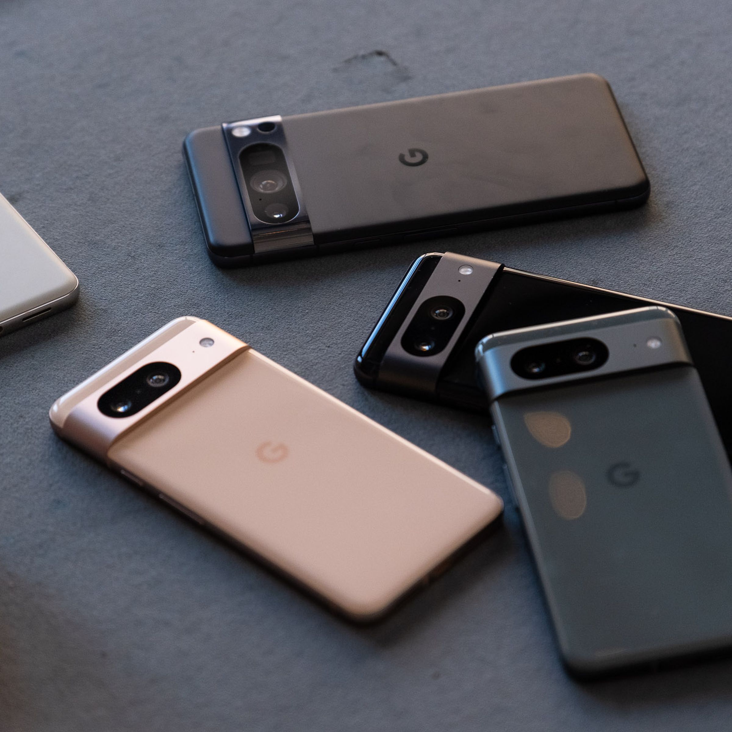 A pile of five Pixel 8 devices.