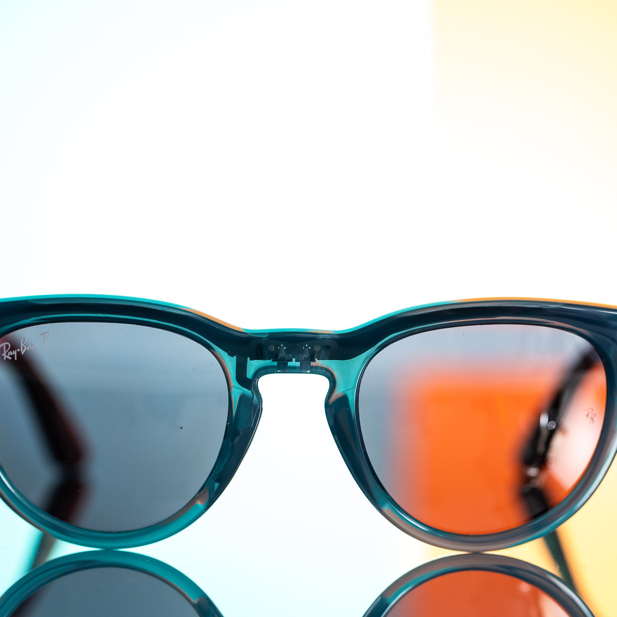 Front view of the Ray-Ban Meta smart glasses on a colorful background