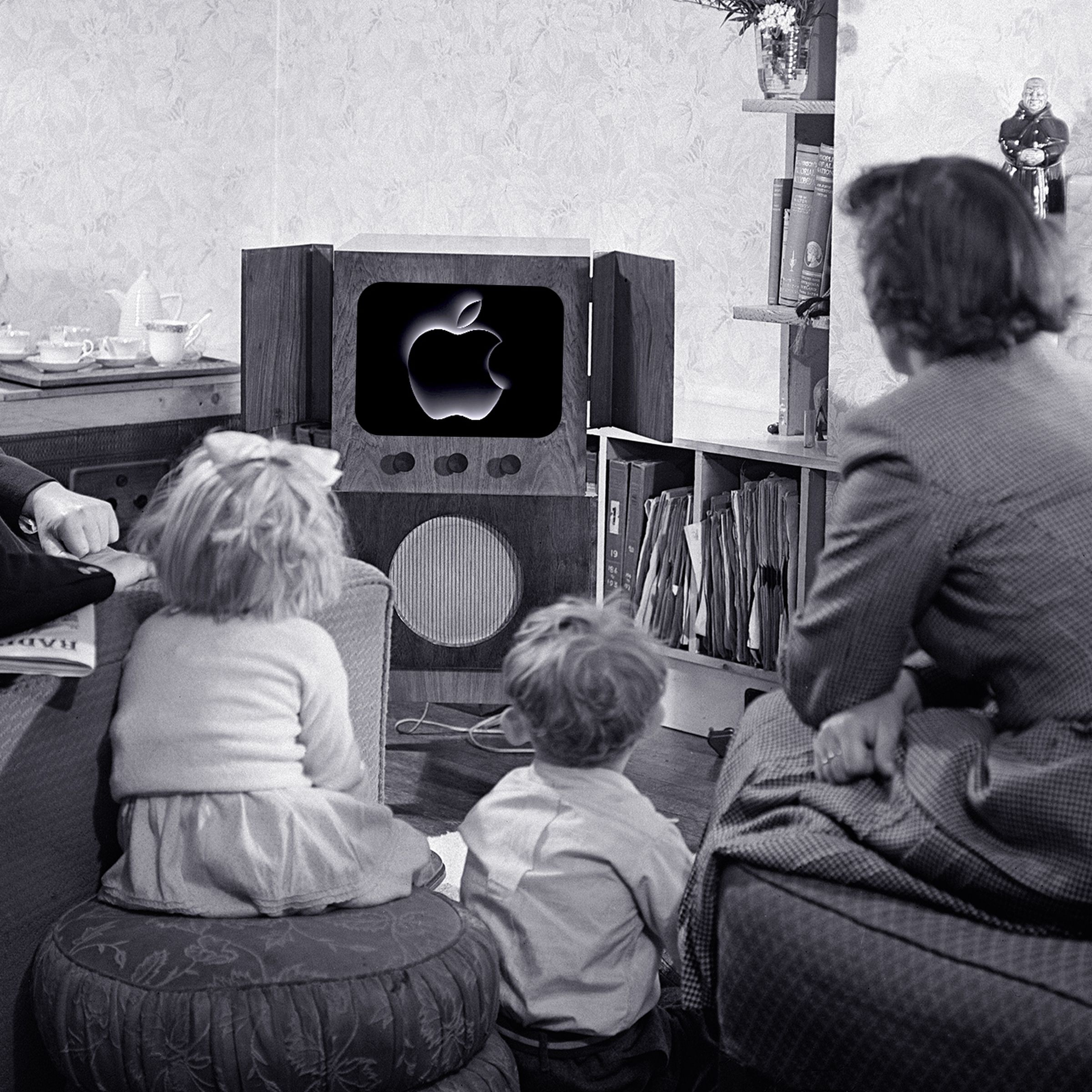 A black-and-white photo of a family watching the Apple event on a TV.