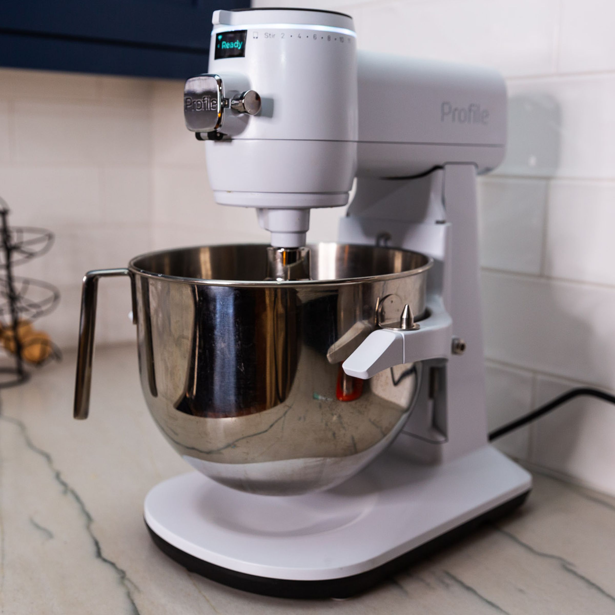 A white stand mixer on a kitchen countertop.