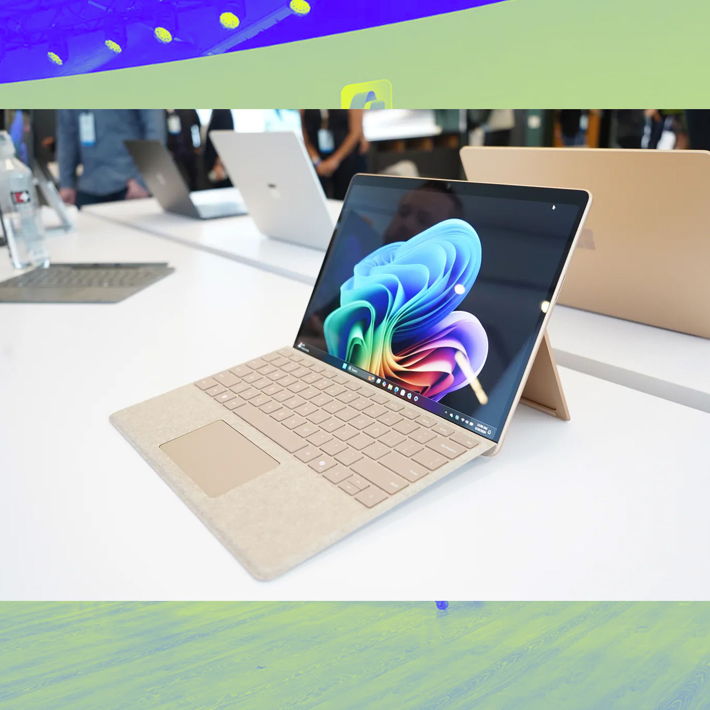 A photo of the Surface Laptop, on top of a Vergecast illustration.