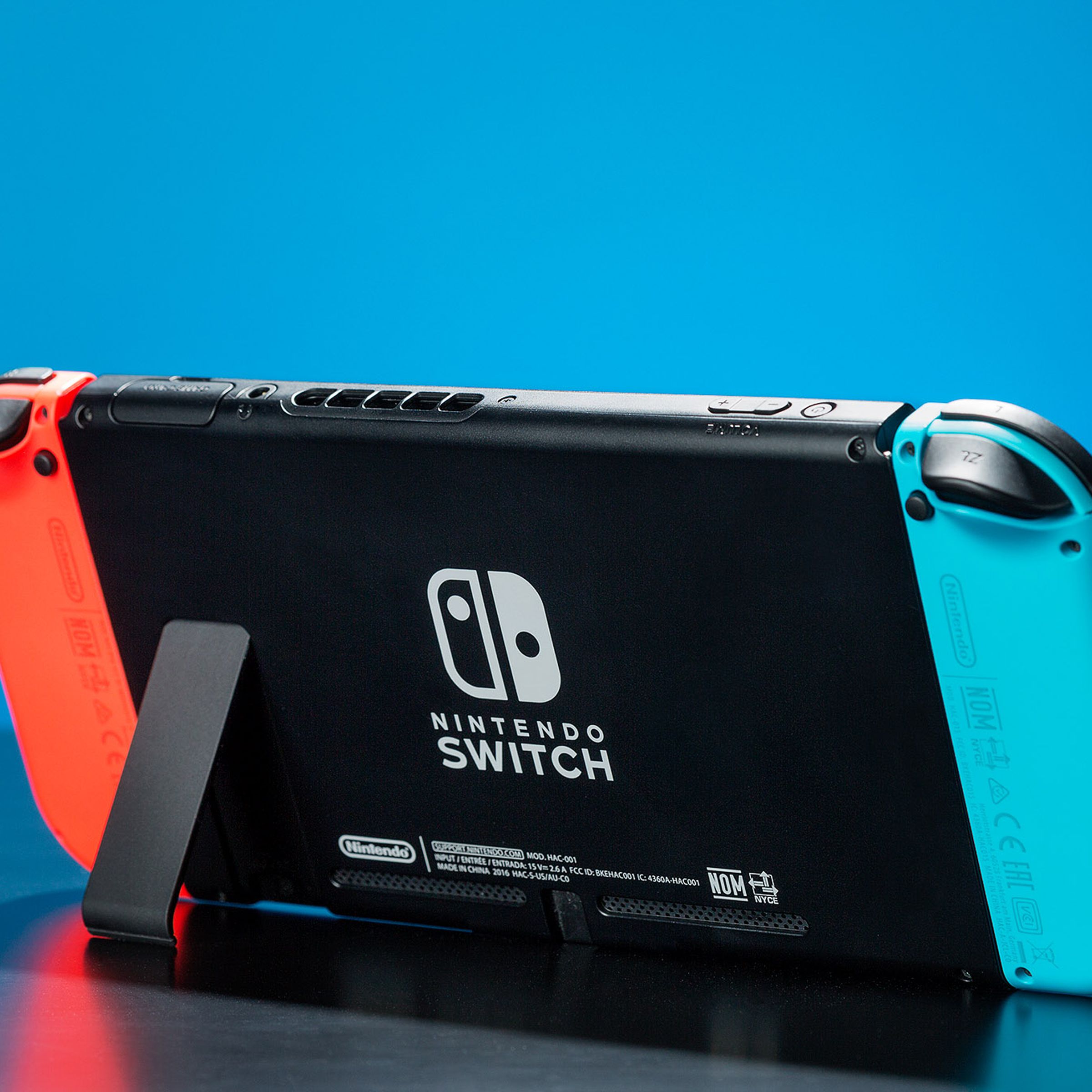 An image of a Nintendo Switch on a table with its kickstand extended.