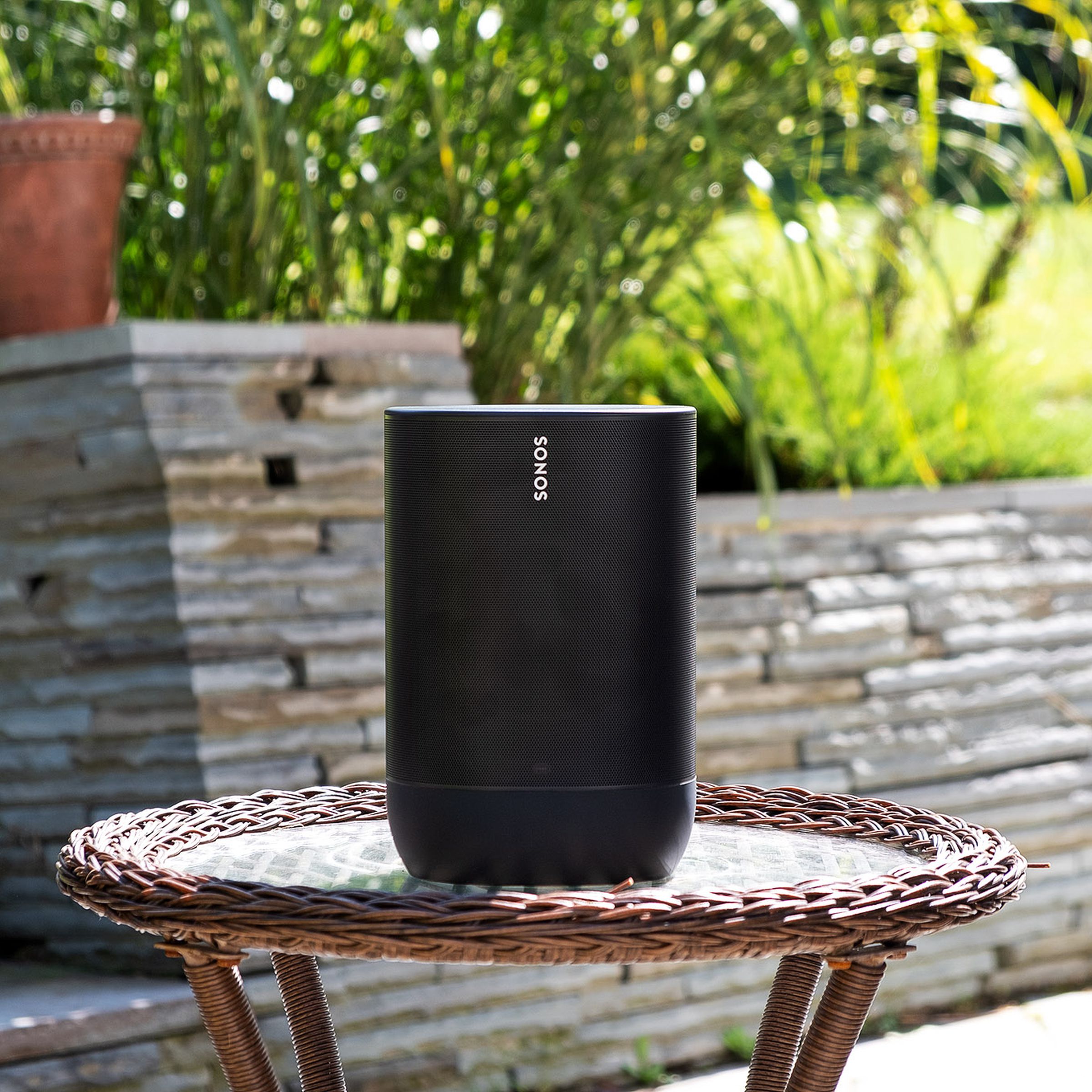 A photo of the Sonos Move speaker on a backyard patio.