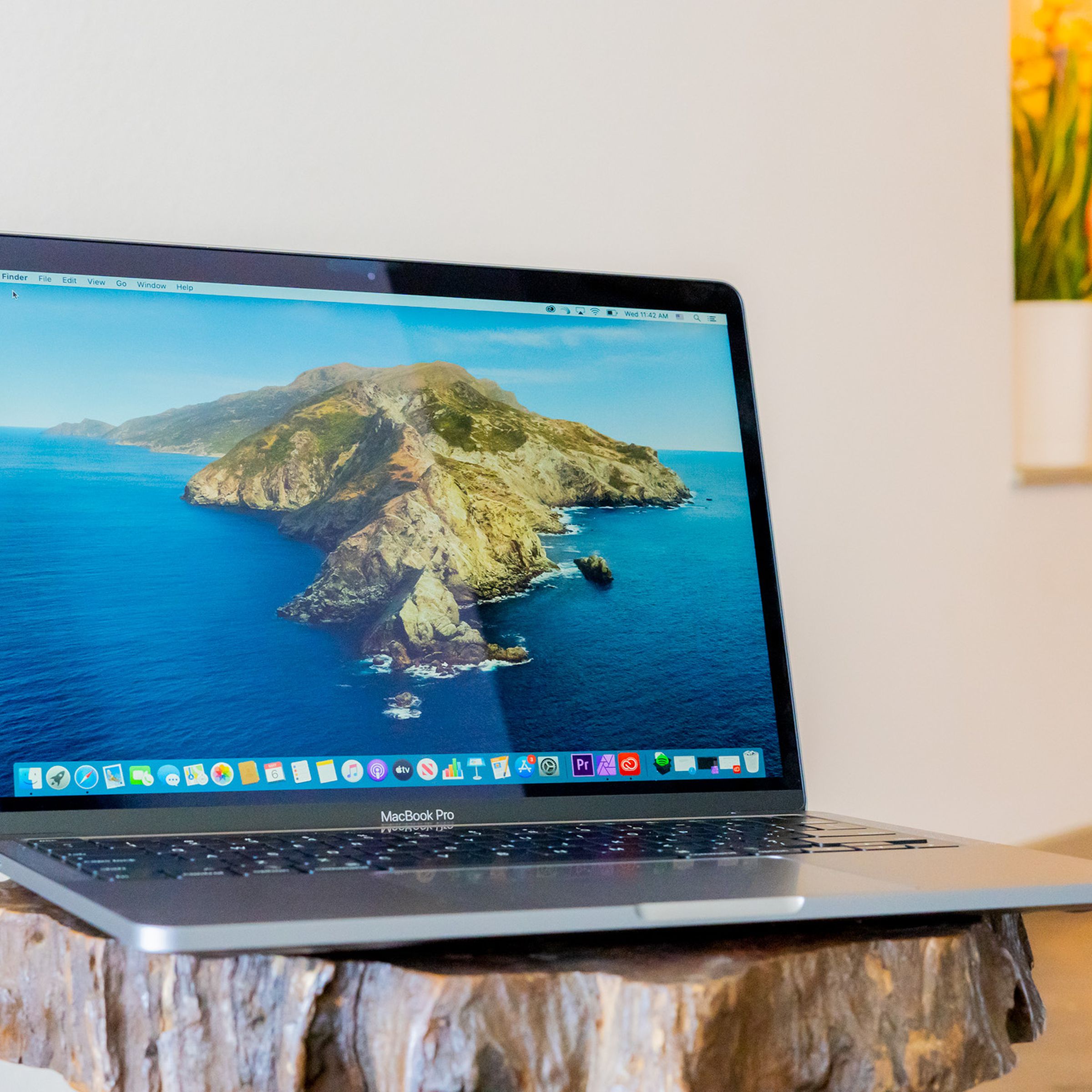 A 2020 Apple MacBook Pro 13-inch on a wooden table