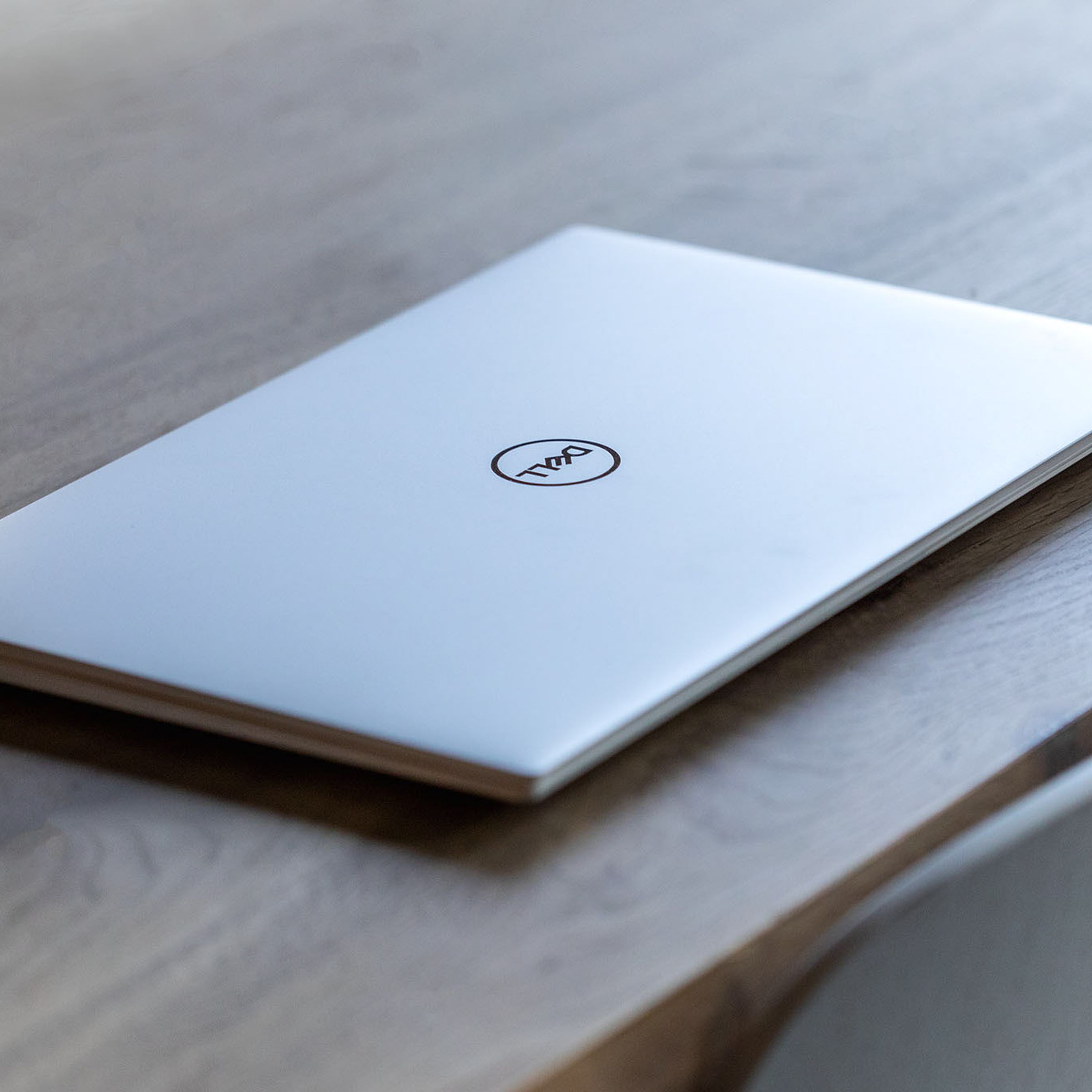 The Dell XPS 15 closed on a wooden table.