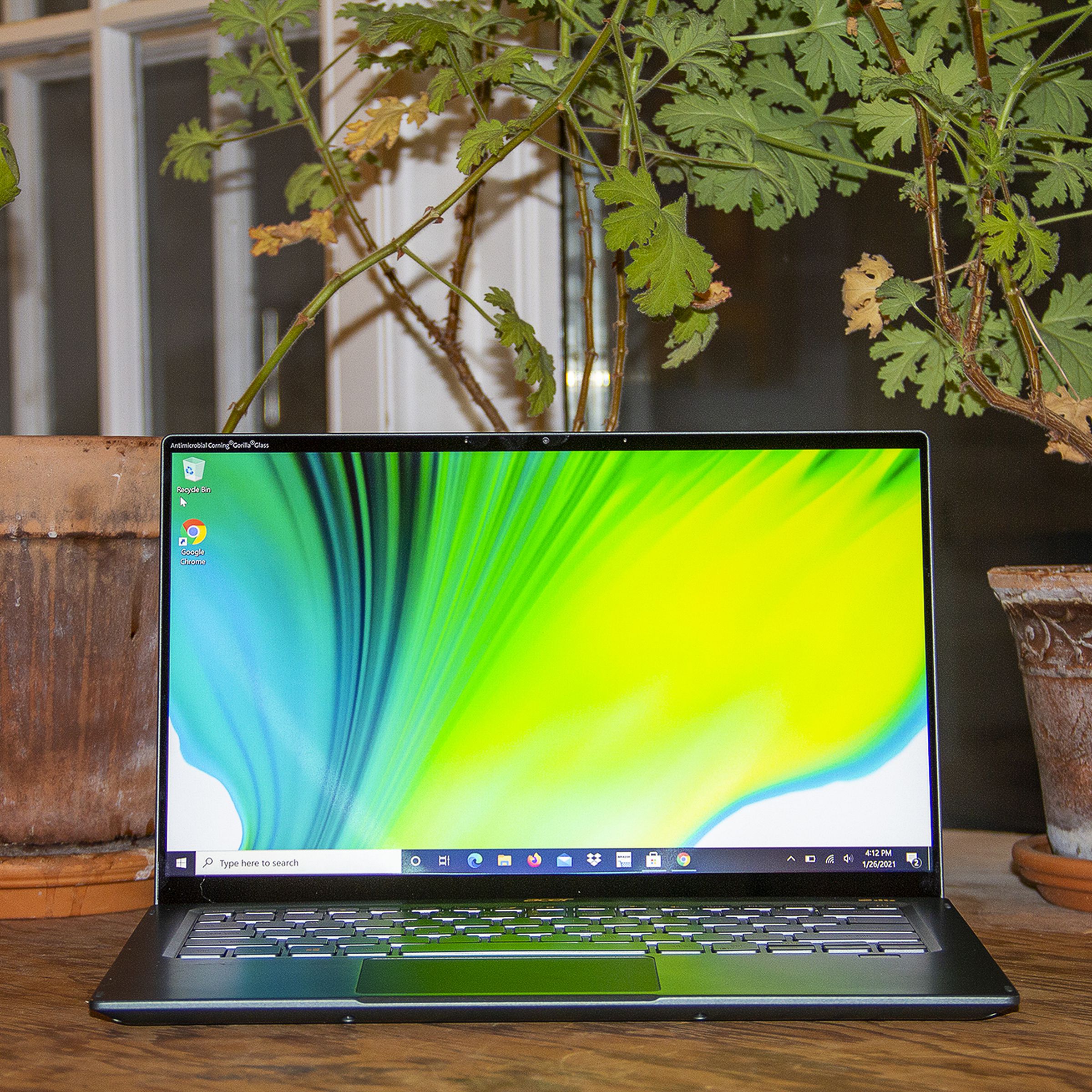 The Acer Swift 5 open, seen from the front. The screen depicts a green, blue, and white background.