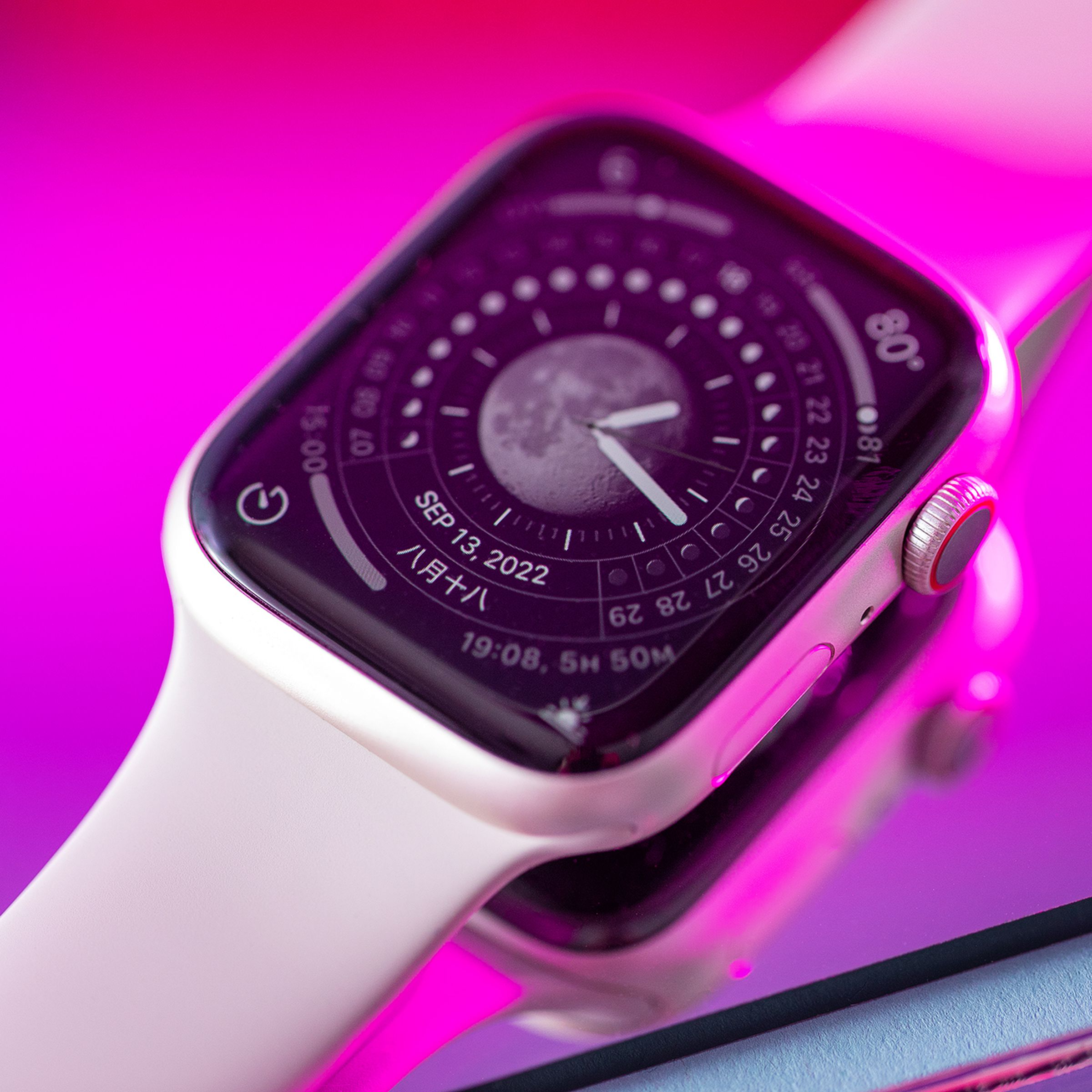 The Apple Watch Series 8 on a reflective pink mirror