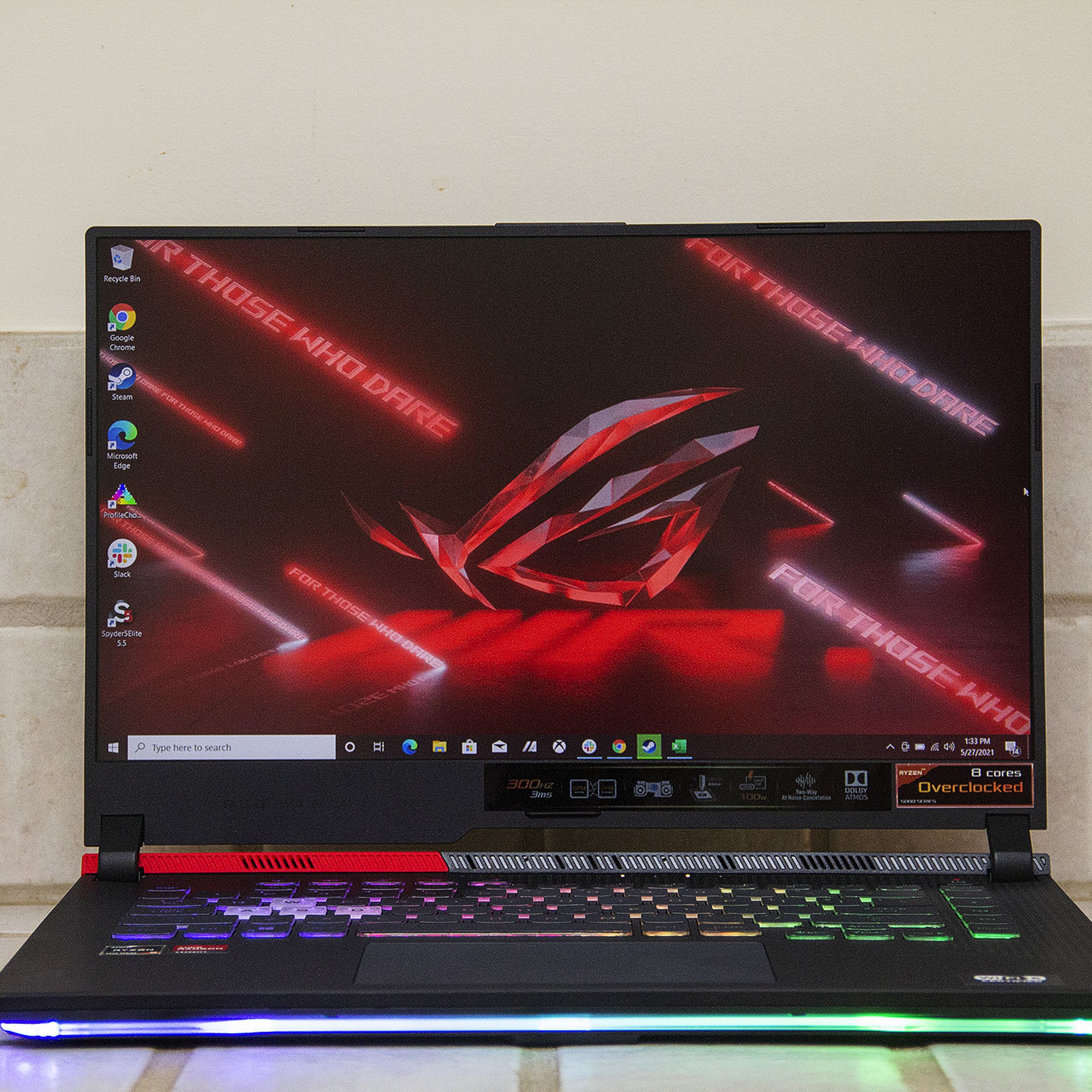The Asus ROG Strix G15 Advantage Edition seen from teh front, open. The screen displays the ROG logo on a red background.