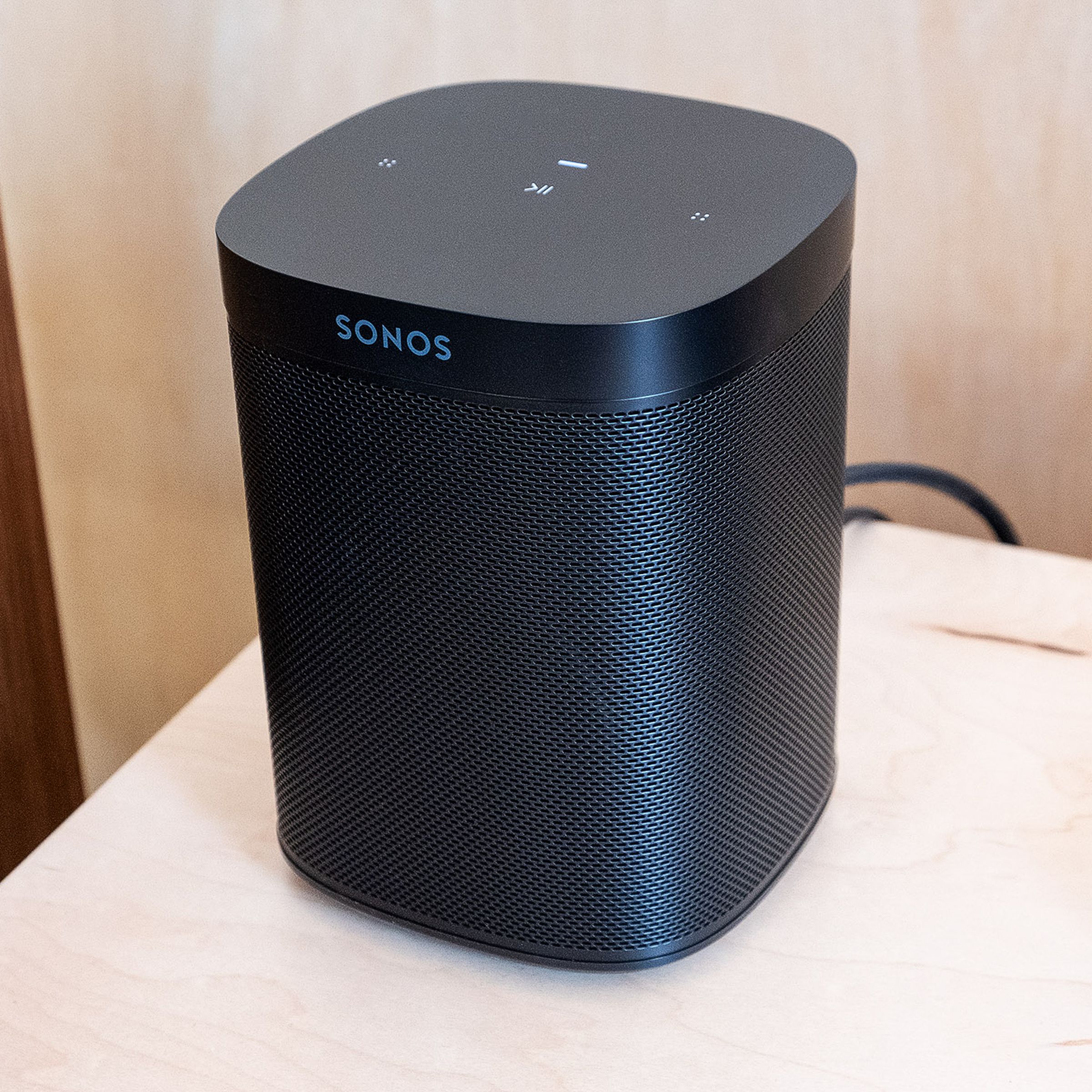 The Sonos One SL sitting on a table.