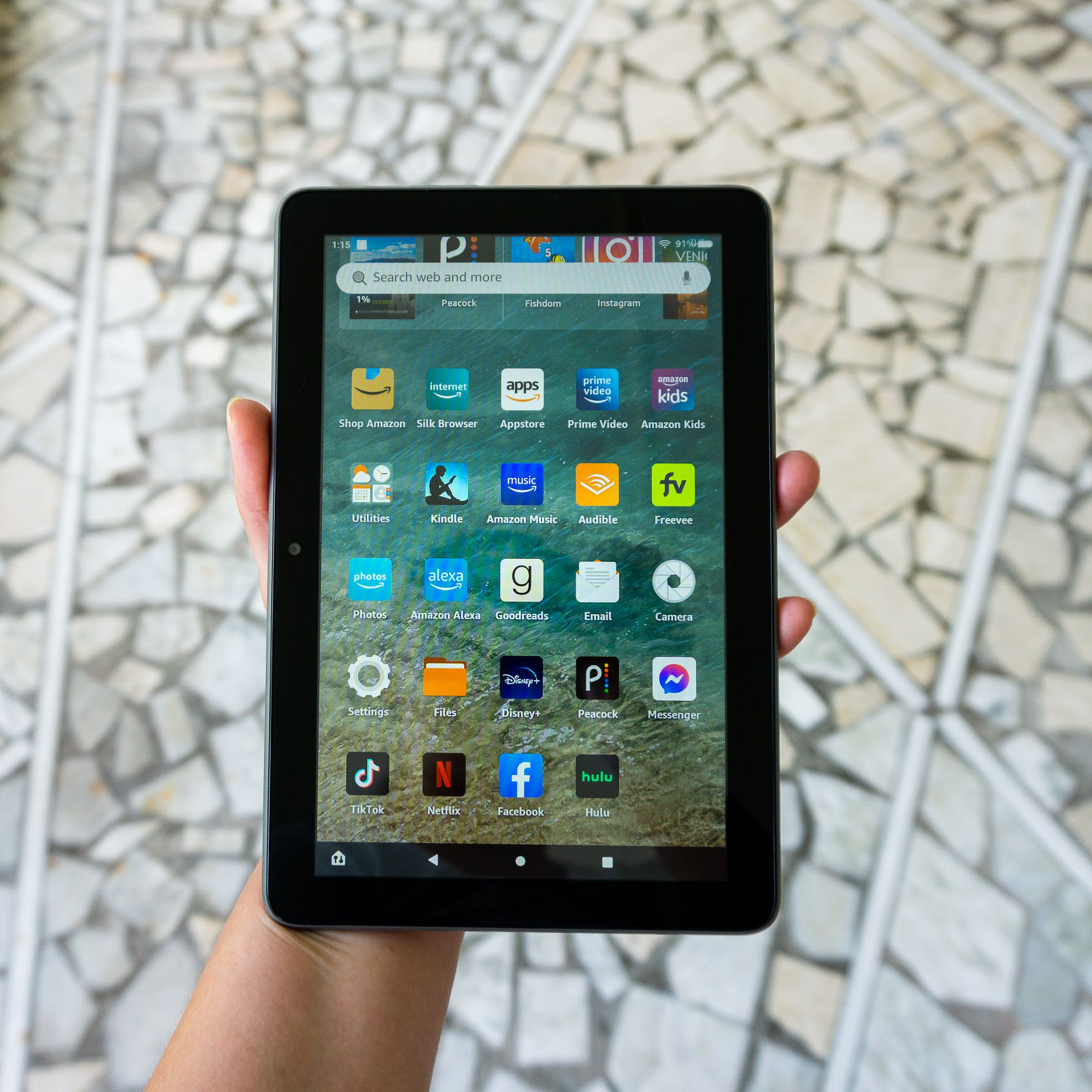 A person holding the Amazon Fire HD 8 Plus tablet