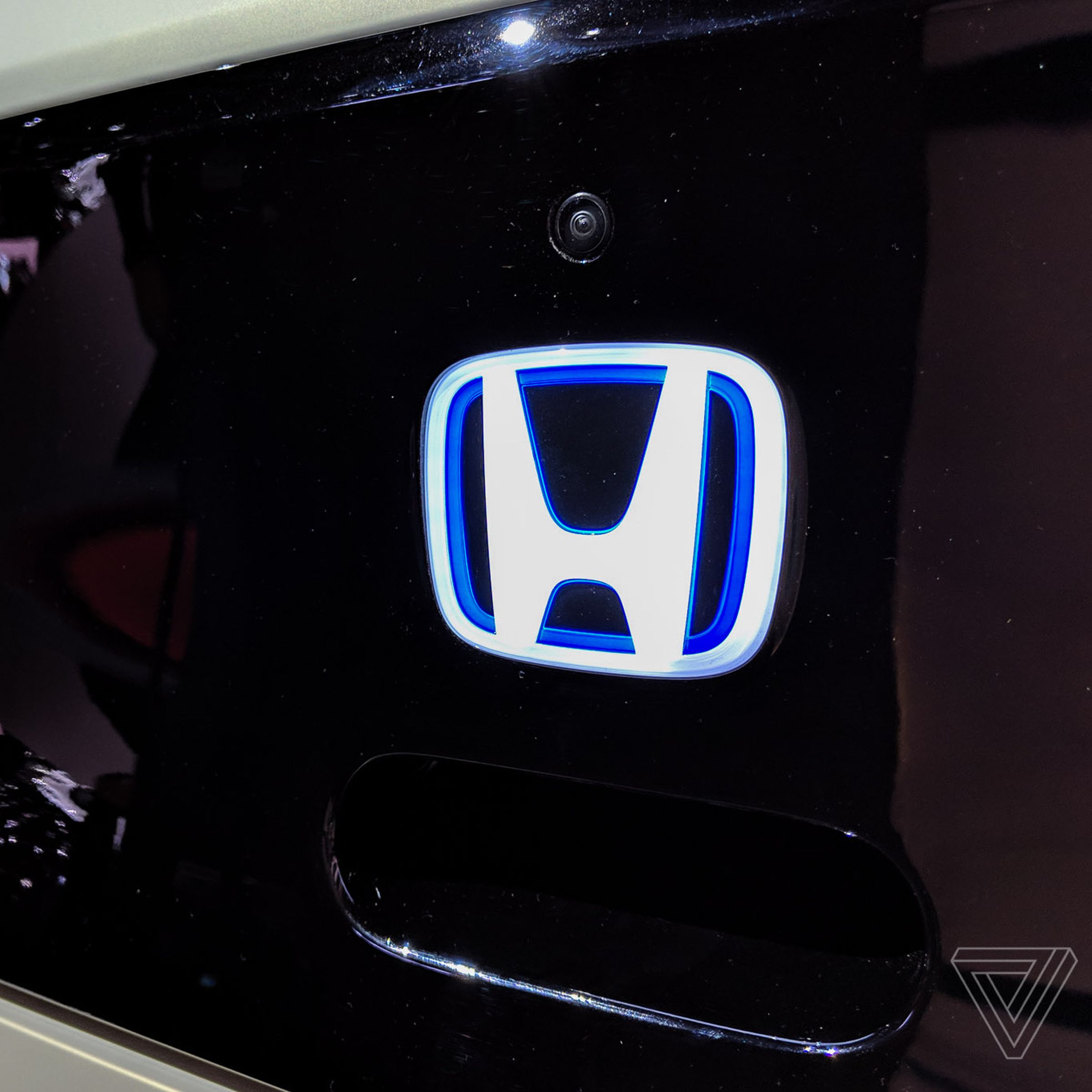 A lit-up Honda logo