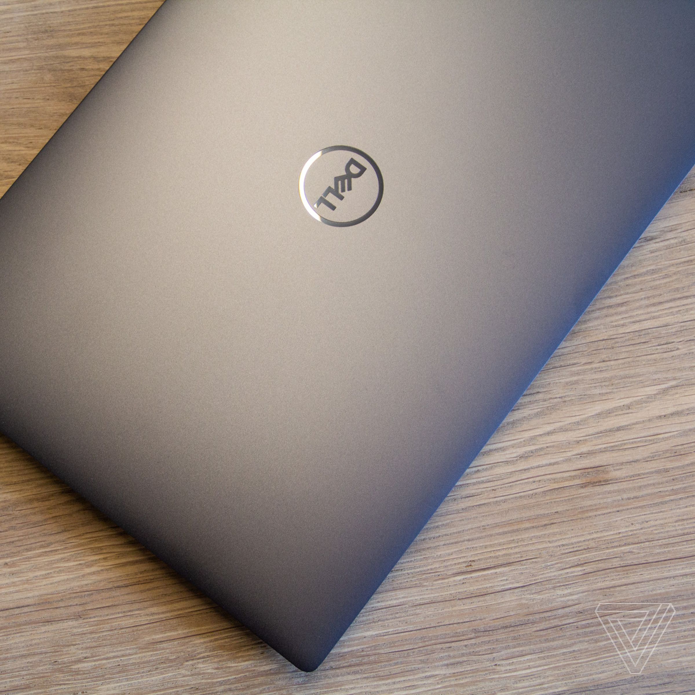 The lid of the Dell XPS 13 Plus on a wooden table seen from above.