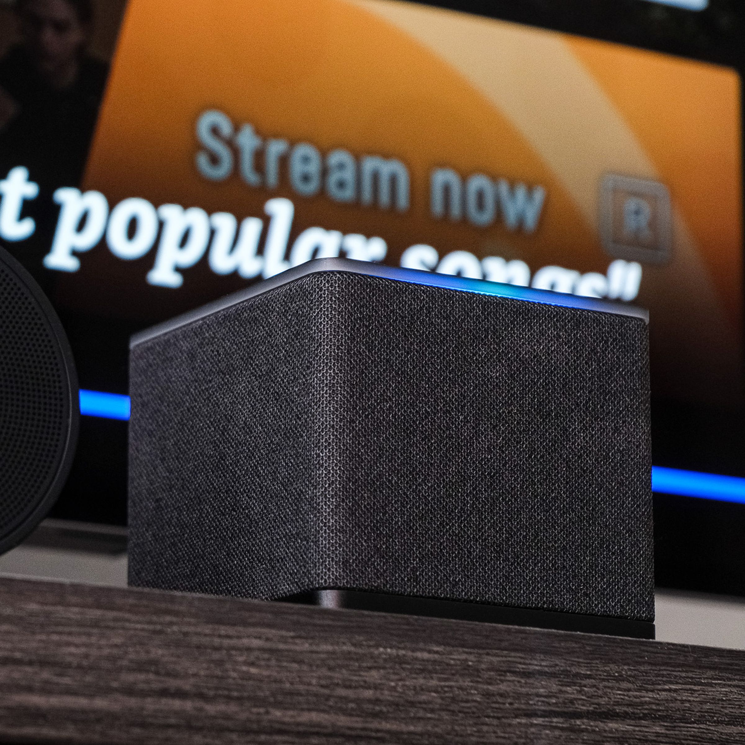 A photo of Amazon’s Fire TV Cube on a TV stand.
