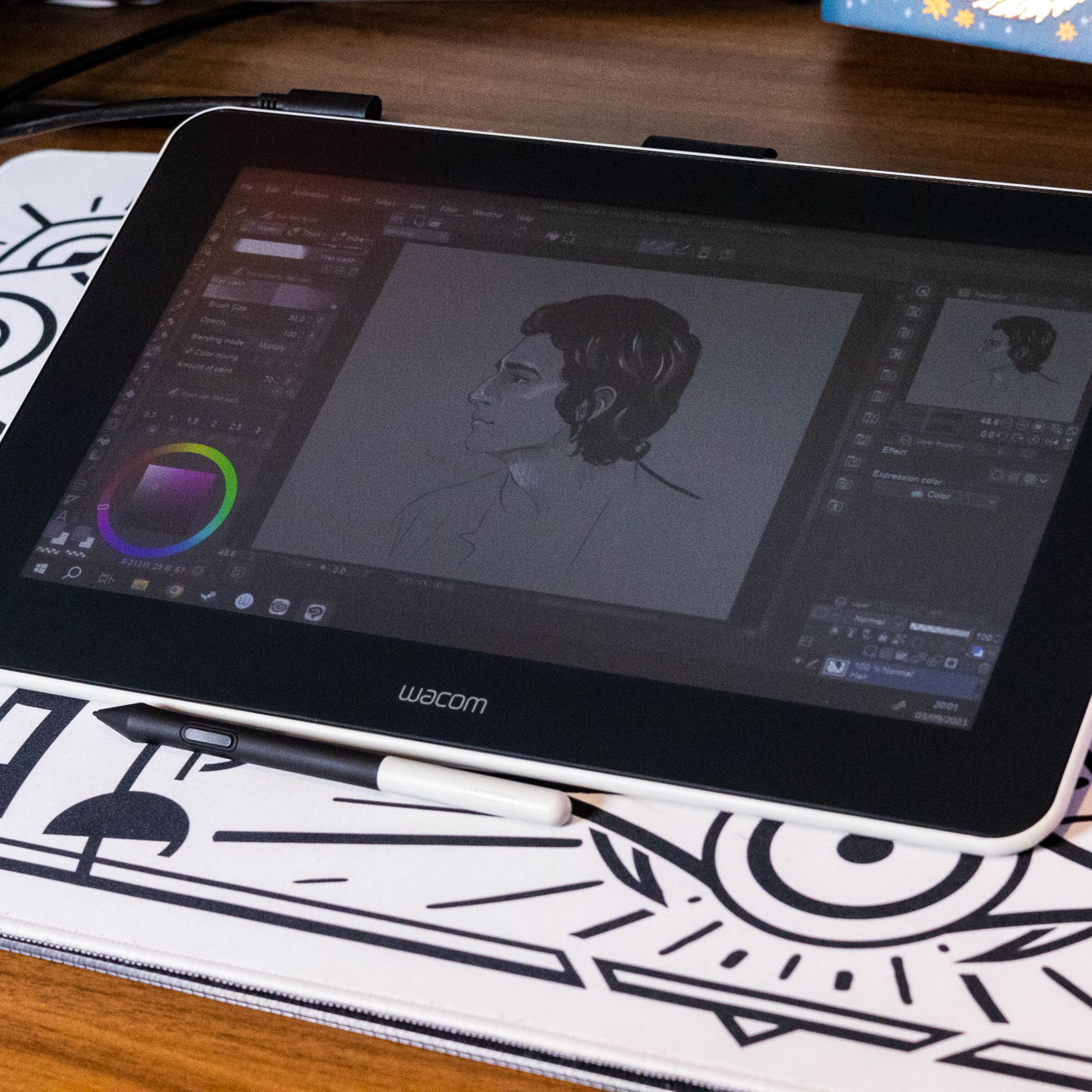 The Wacom One (2019) display tablet on a white desk pad.