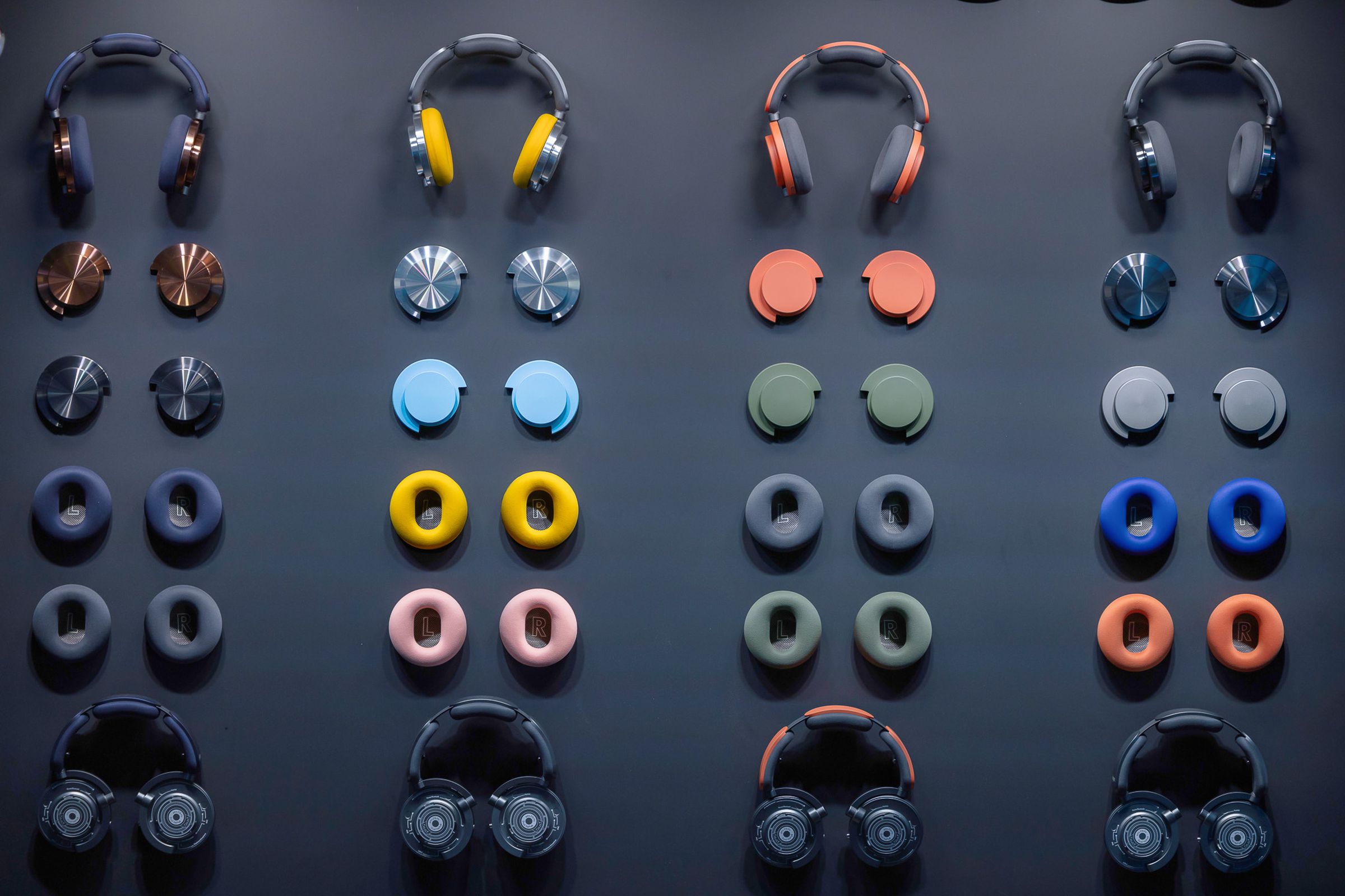 An image showing Dyson’s OnTrac headphones with many different ear cushions and ear cups.