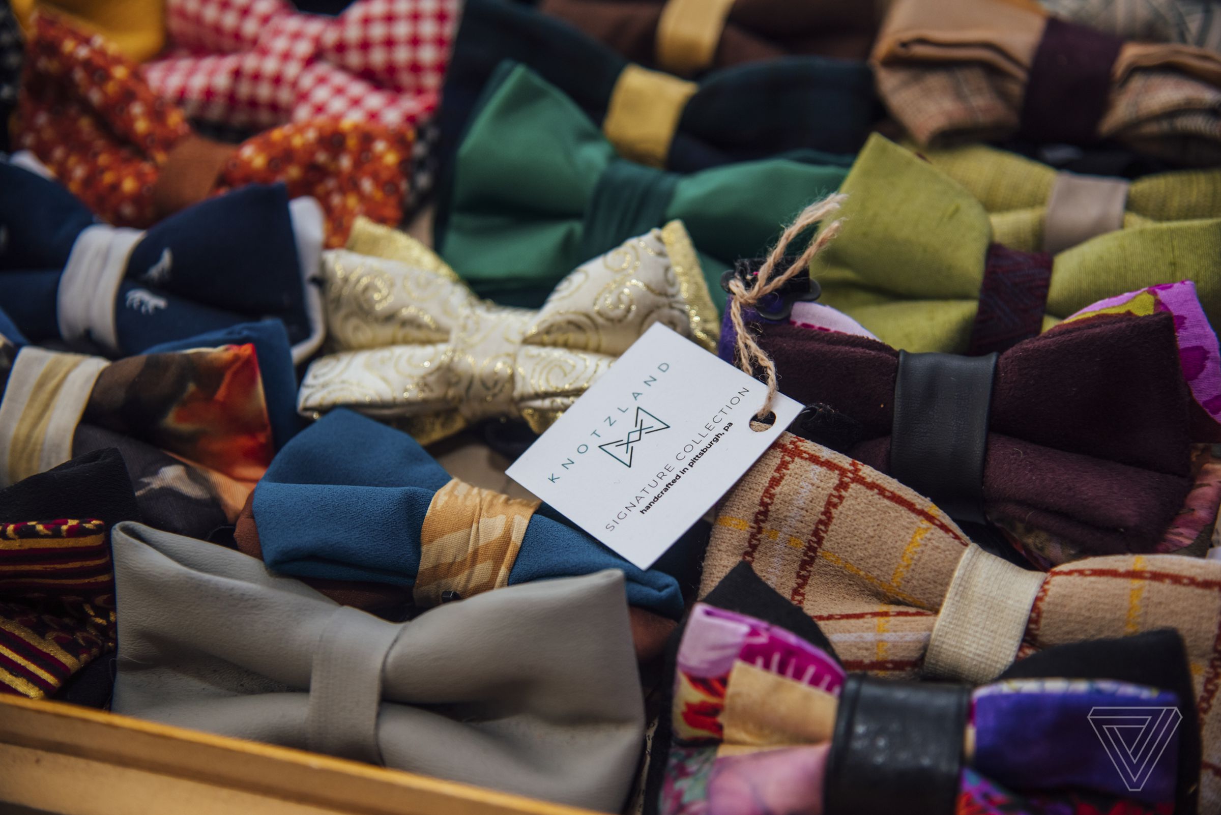 Knotzland bow ties, made from upcycled textile waste, are displayed on a table